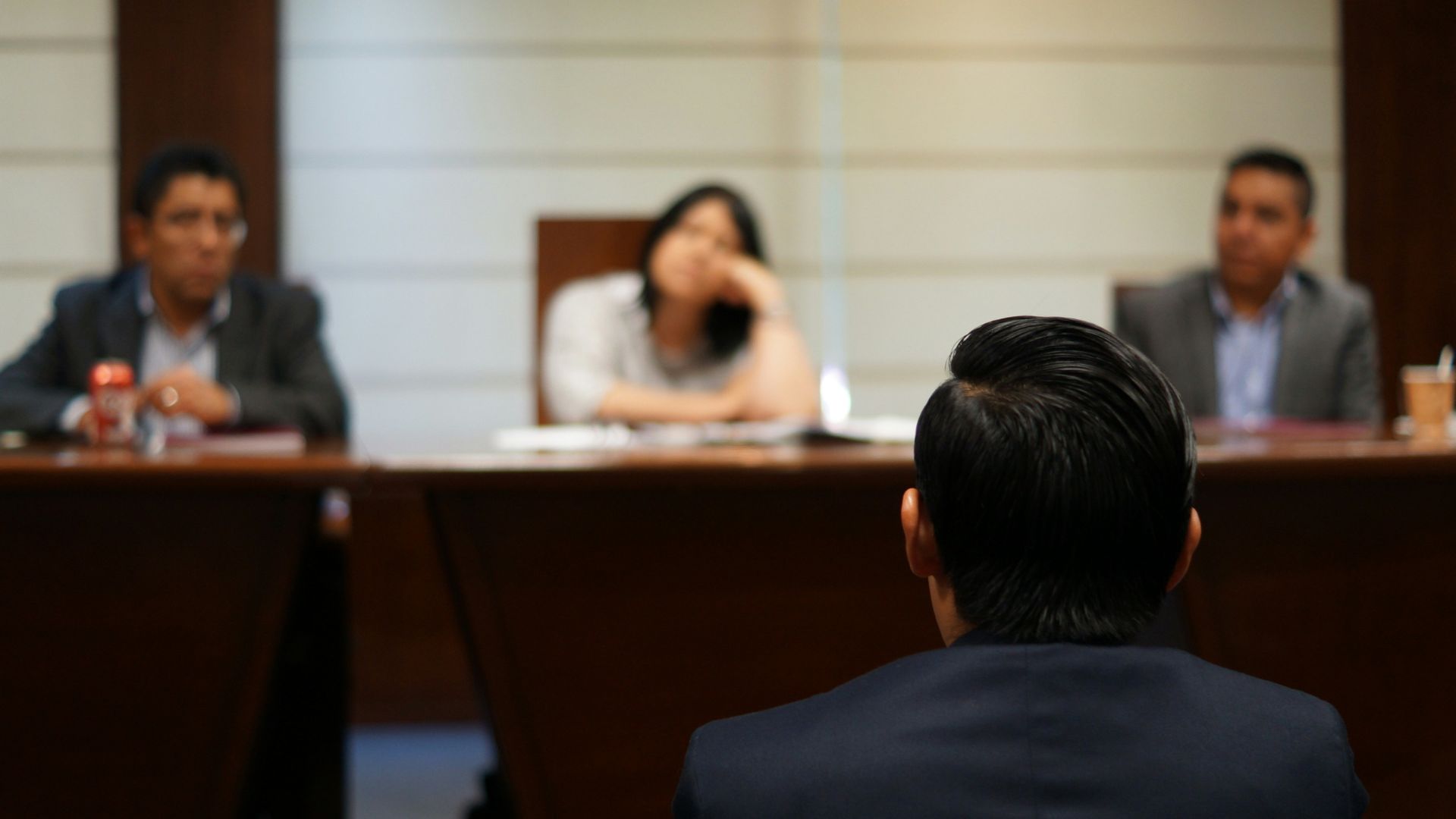 Two people reviewing documents at a table during a meeting