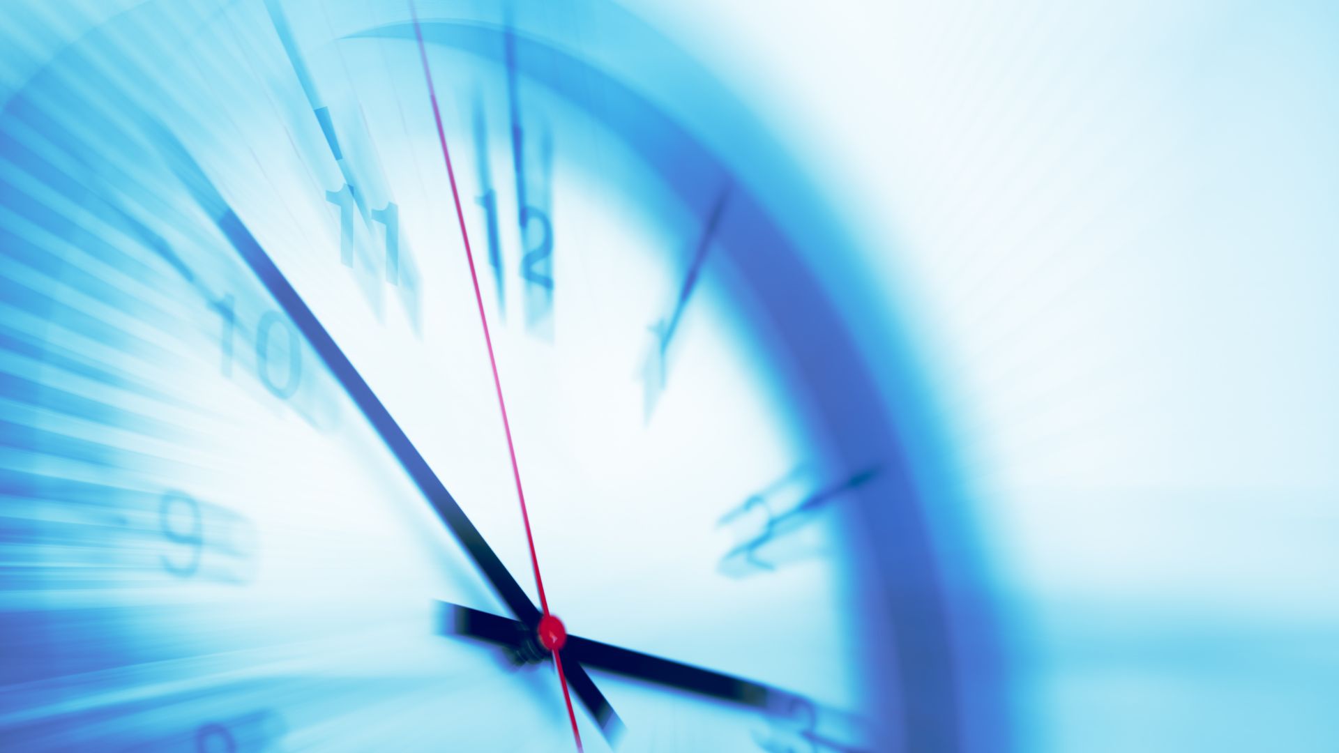 Blurred clock face showing fast motion and streaked numbers