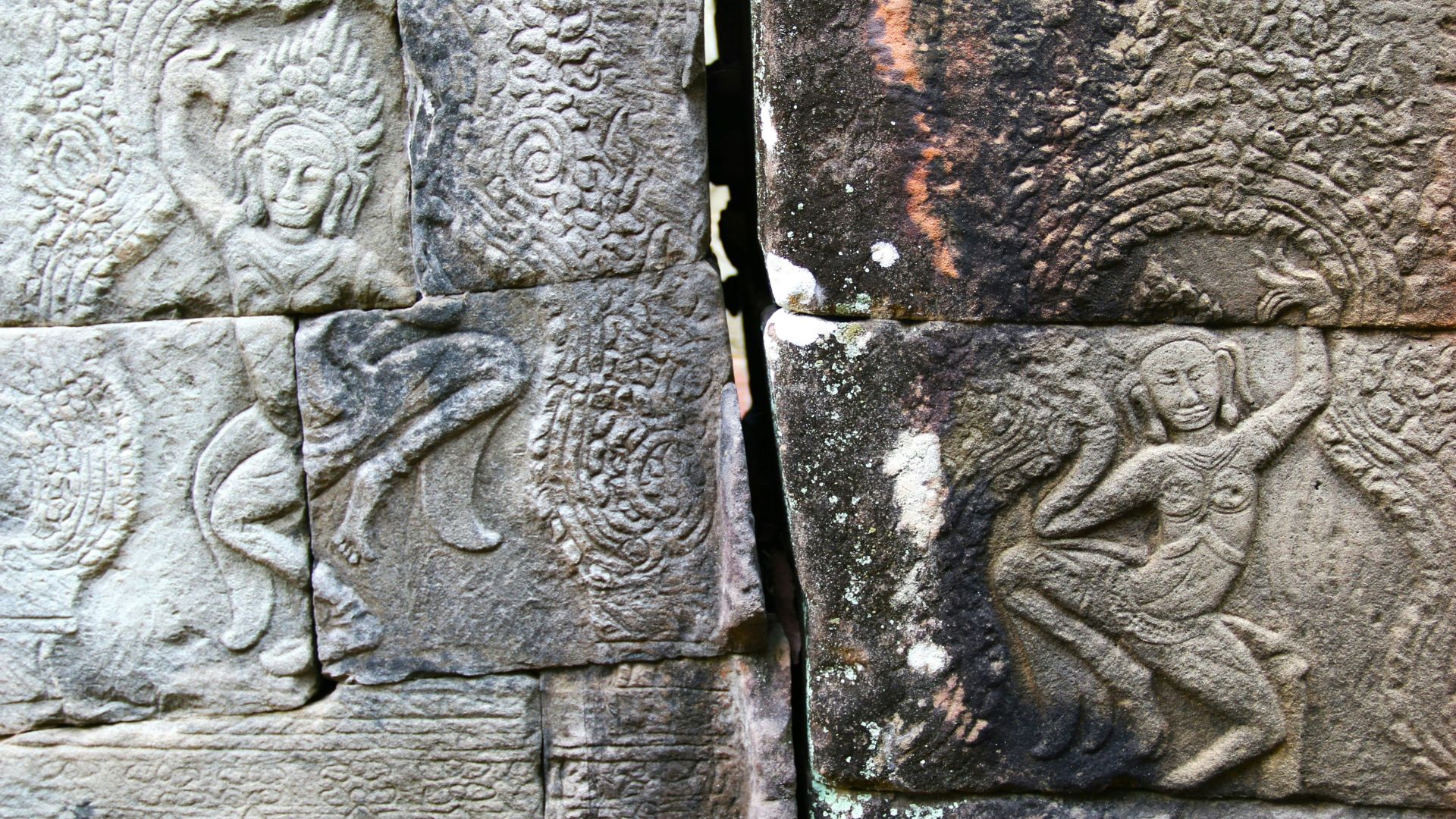 Close-up of a stone wall with ancient carvings and markings