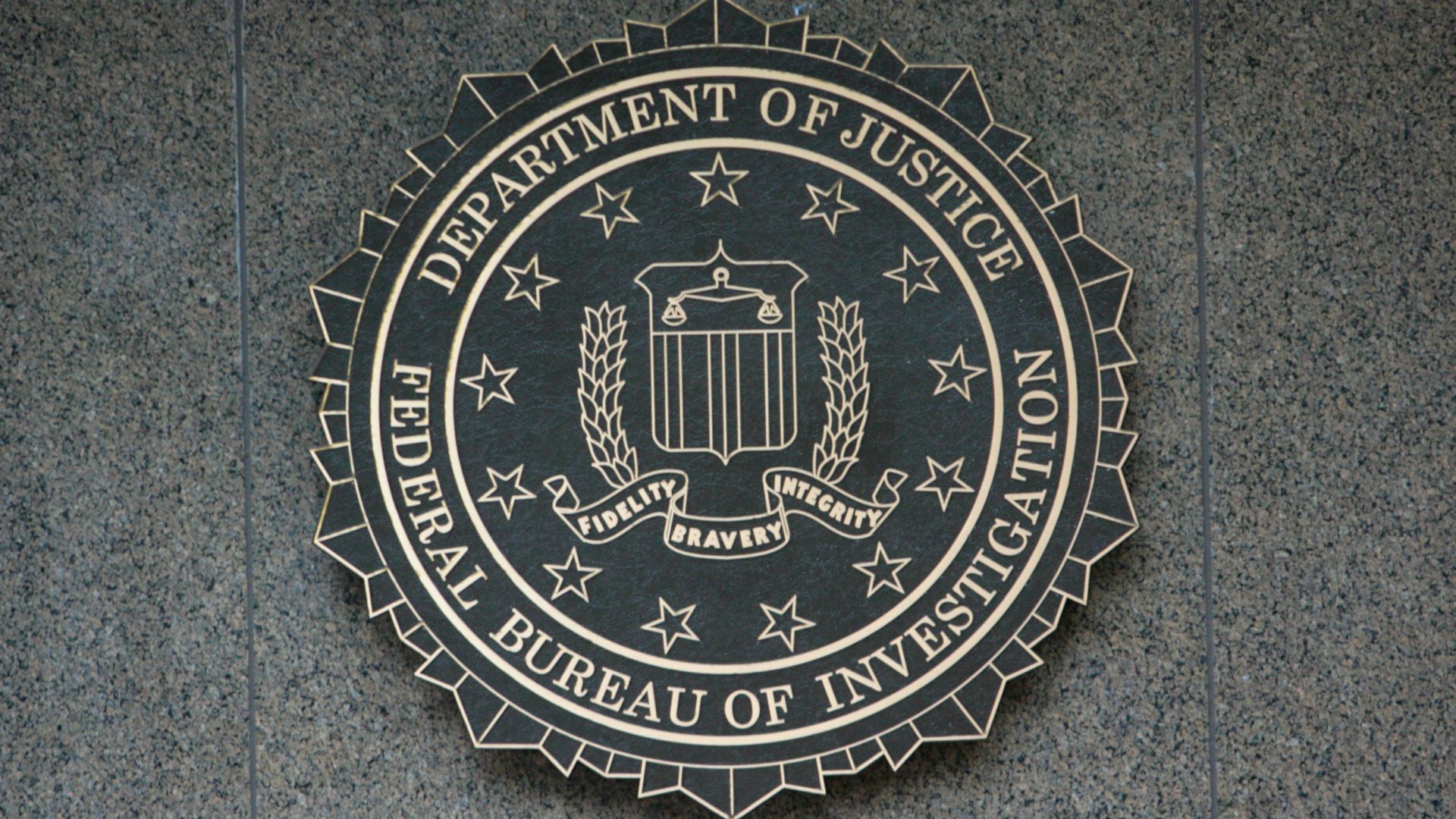 Seal of the United States Department of Justice mounted on a wall