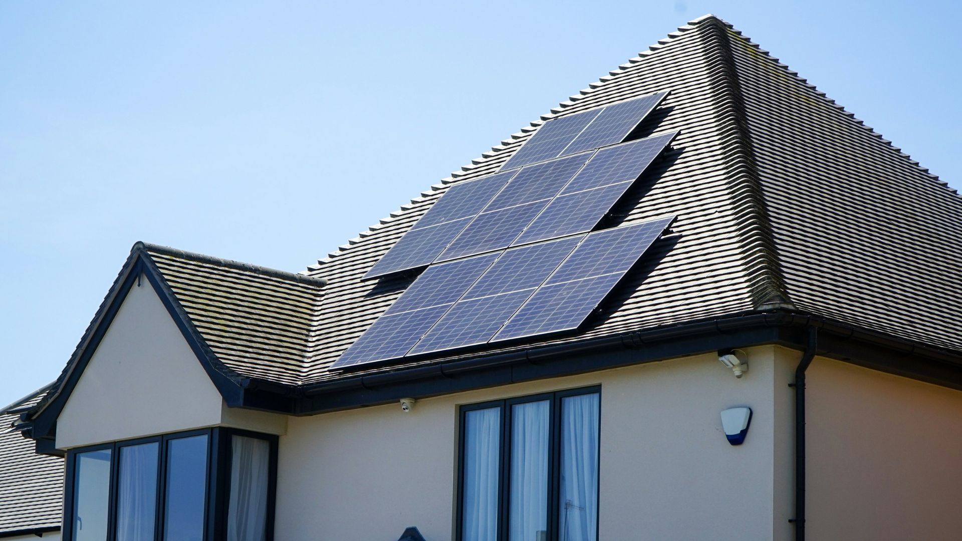 House with rooftop solar panels in daylight