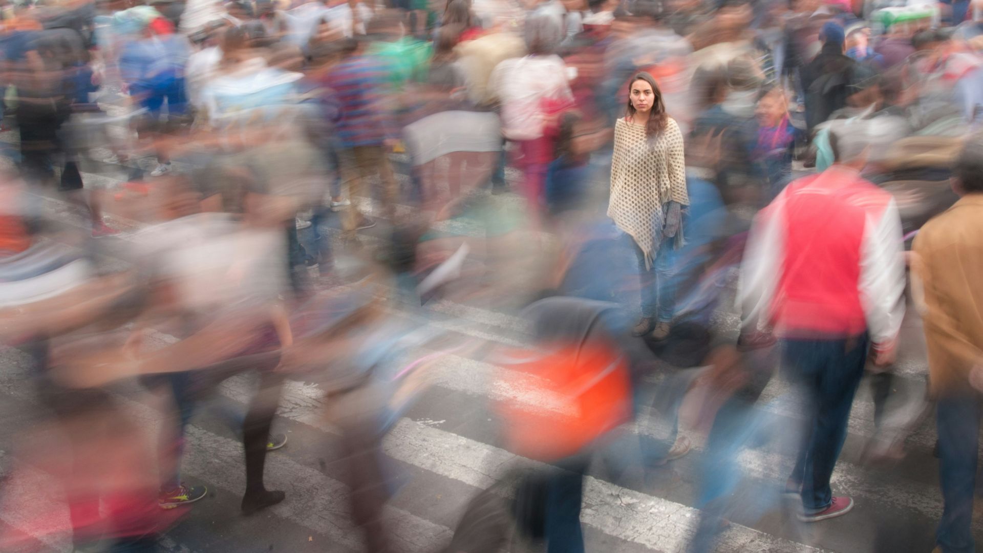 People walking down a busy street during daytime with blurred motion