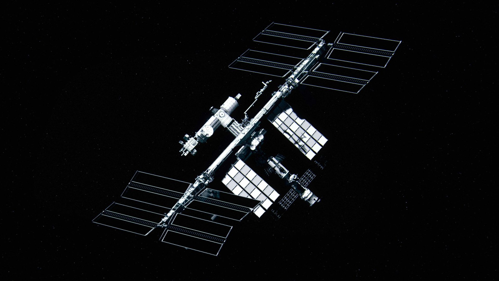 Space station illuminated in the darkness of space with faint lights visible