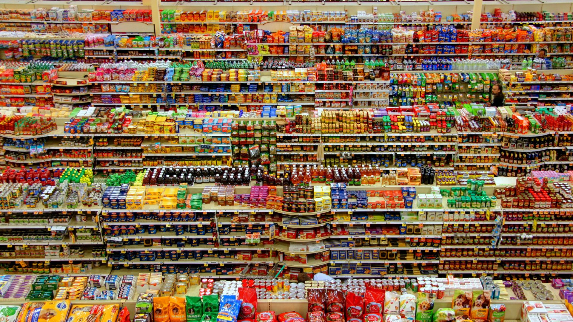 Overhead view of grocery shelves stocked with food and packaged goods