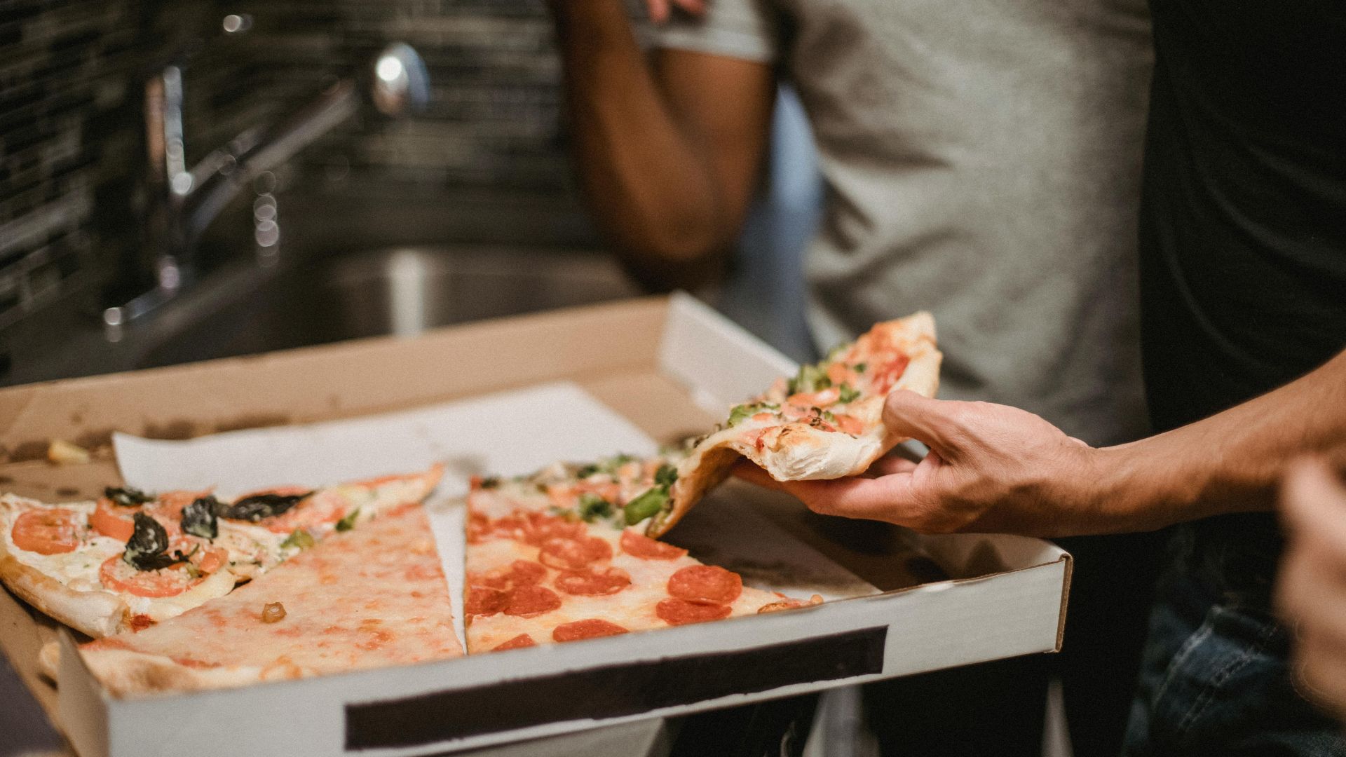 Fresh pizza in an open delivery box