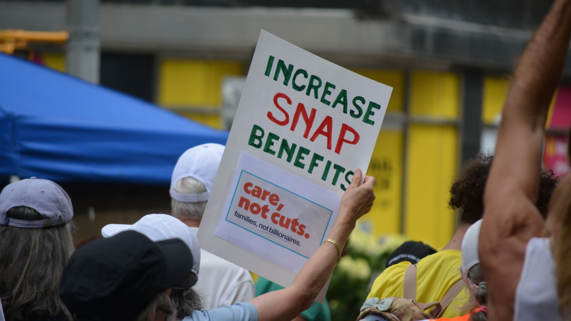 Shoppers walking through a busy grocery store aisle in New York