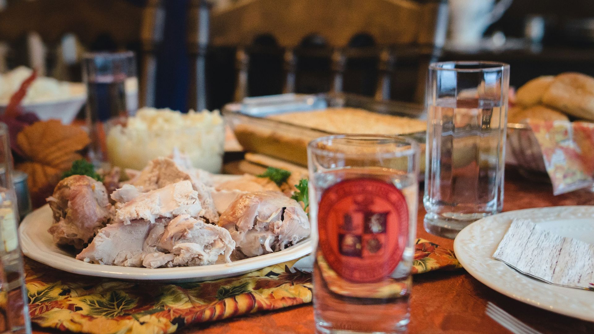 Dinner table set with food and a glass of water ready for a meal