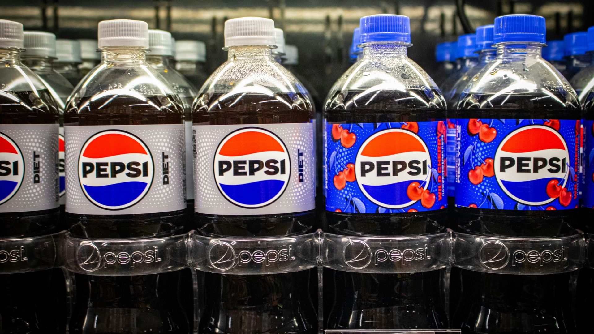 Pepsi products displayed on shelves inside a grocery store