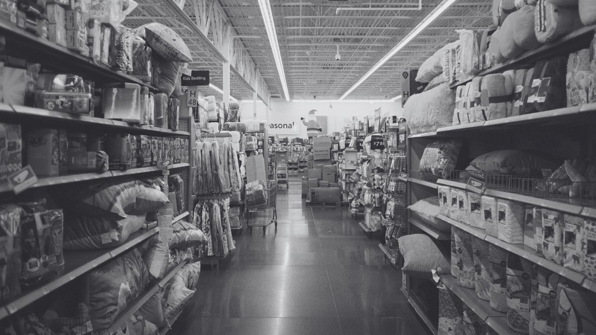 Assorted household and grocery items arranged on a white wooden shelf display.