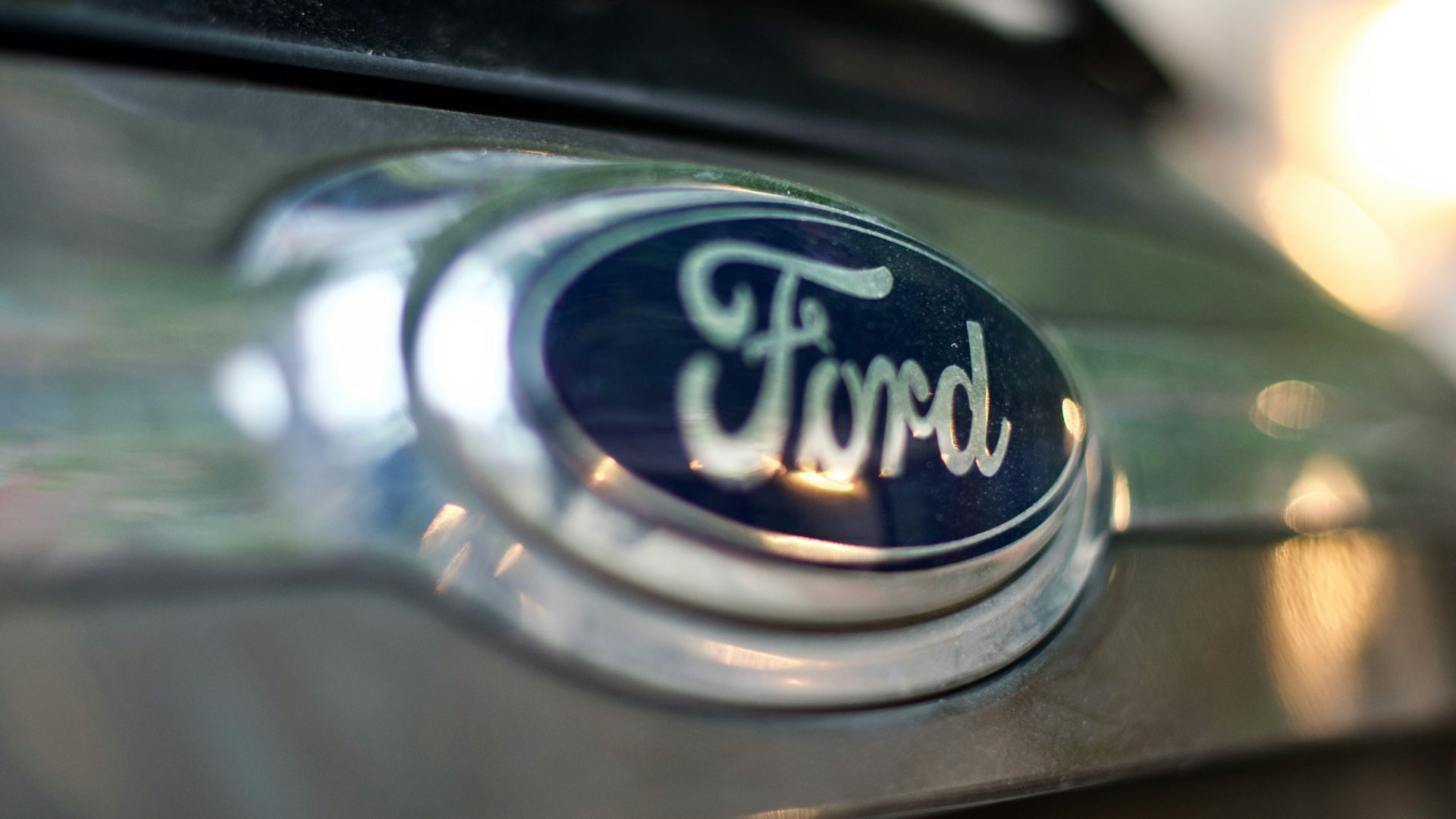 Close up of a Ford logo badge on a vehicle grille