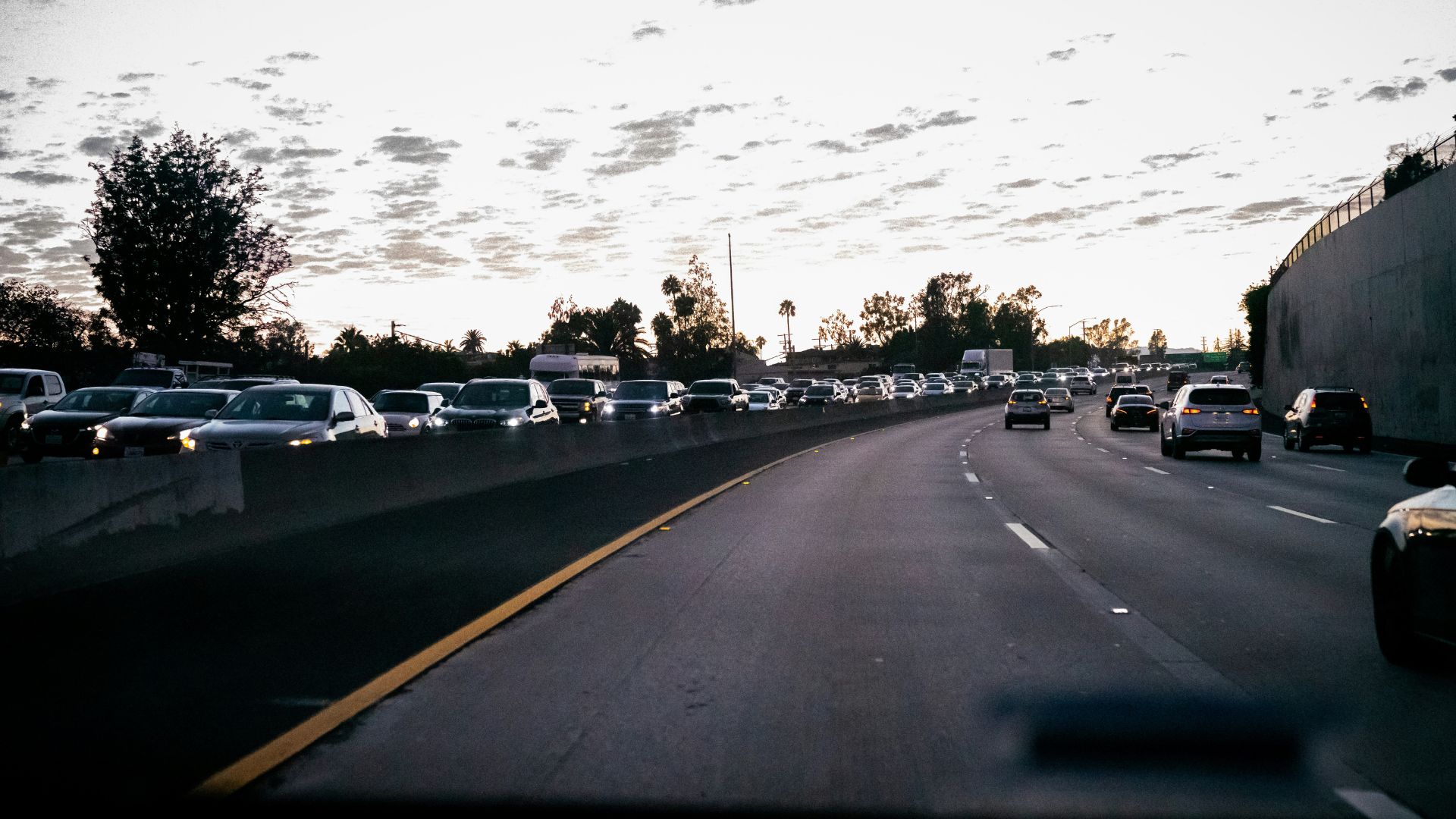 Cars driving along a California roadway under daylight