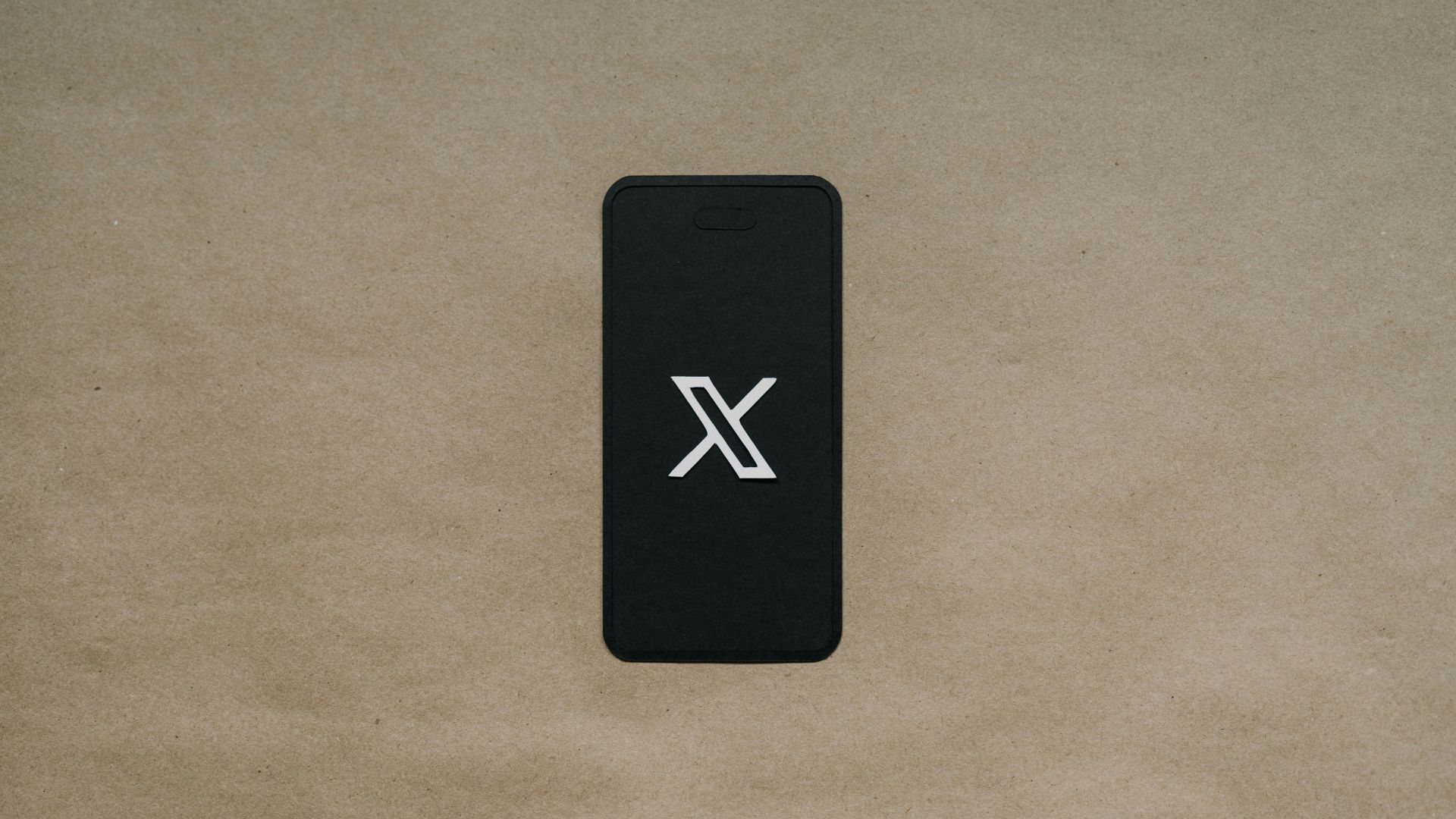 Black smartphone resting on a wooden surface