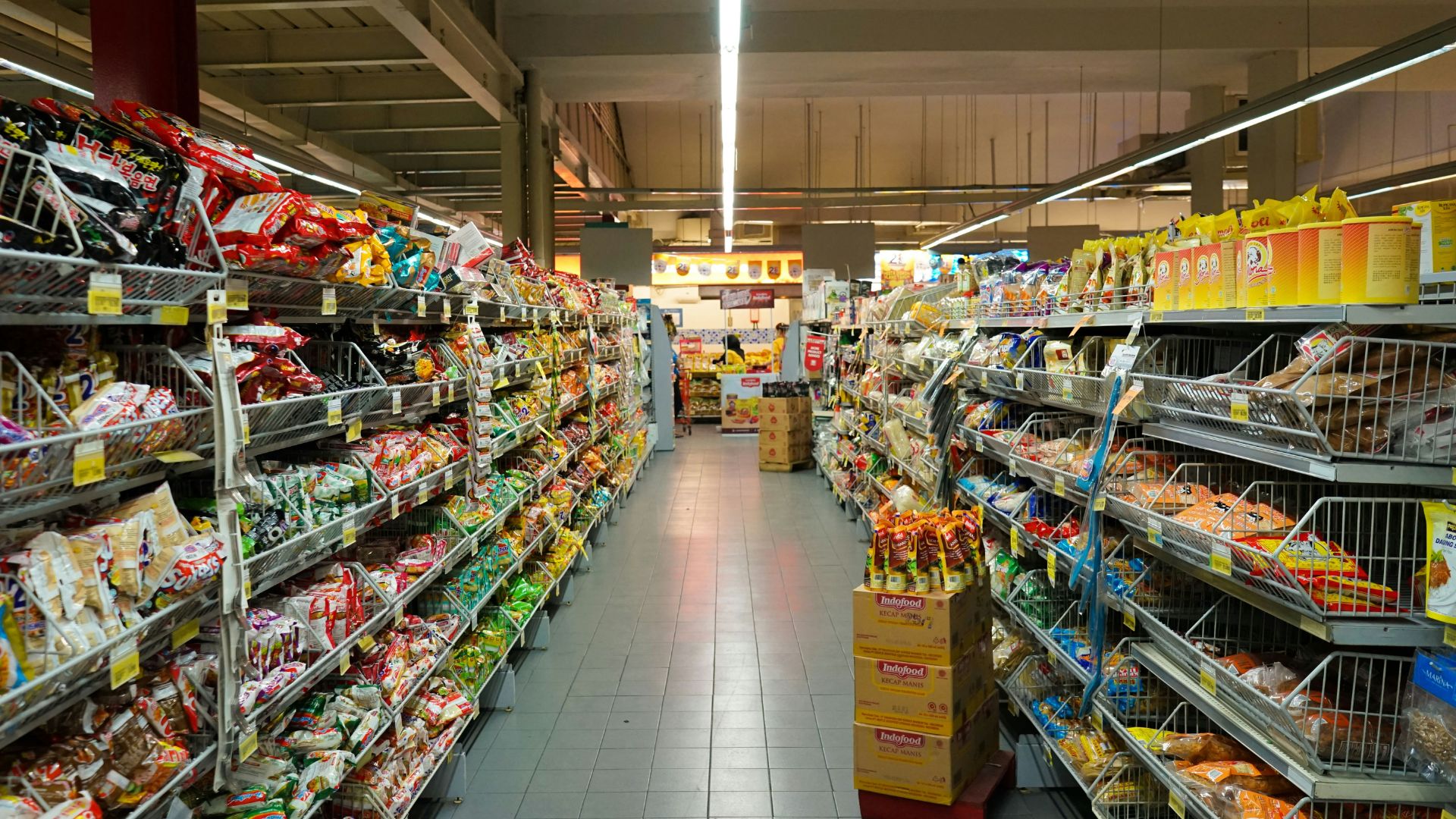 Pile of assorted grocery items and pantry goods stacked together.