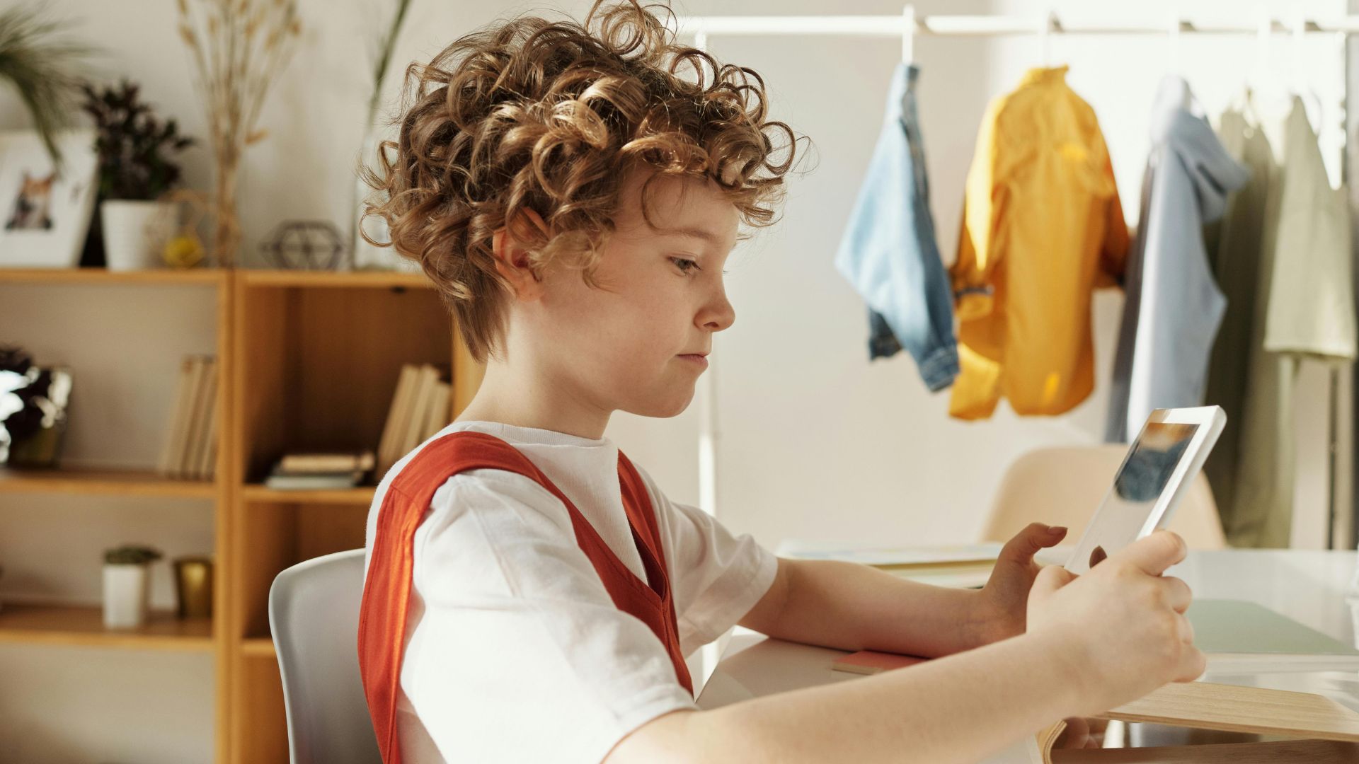 Child sitting using an iPad