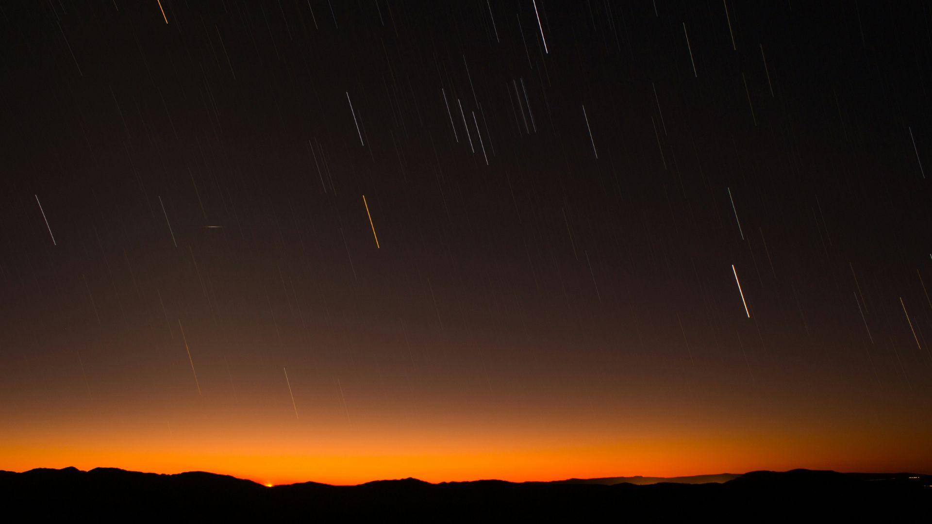 Hill silhouette under a faint moon with subtle nighttime lighting