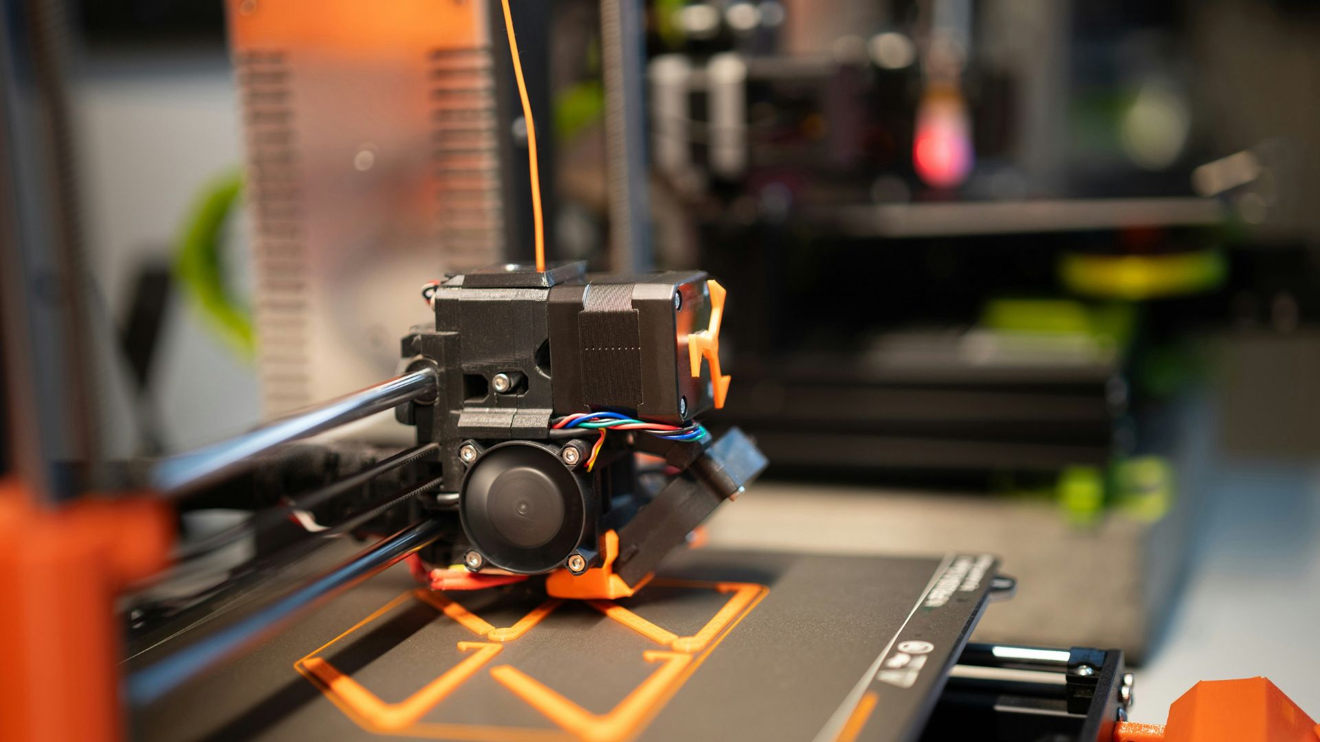 Close up of mechanical assembly with hoses and wiring inside an engine bay