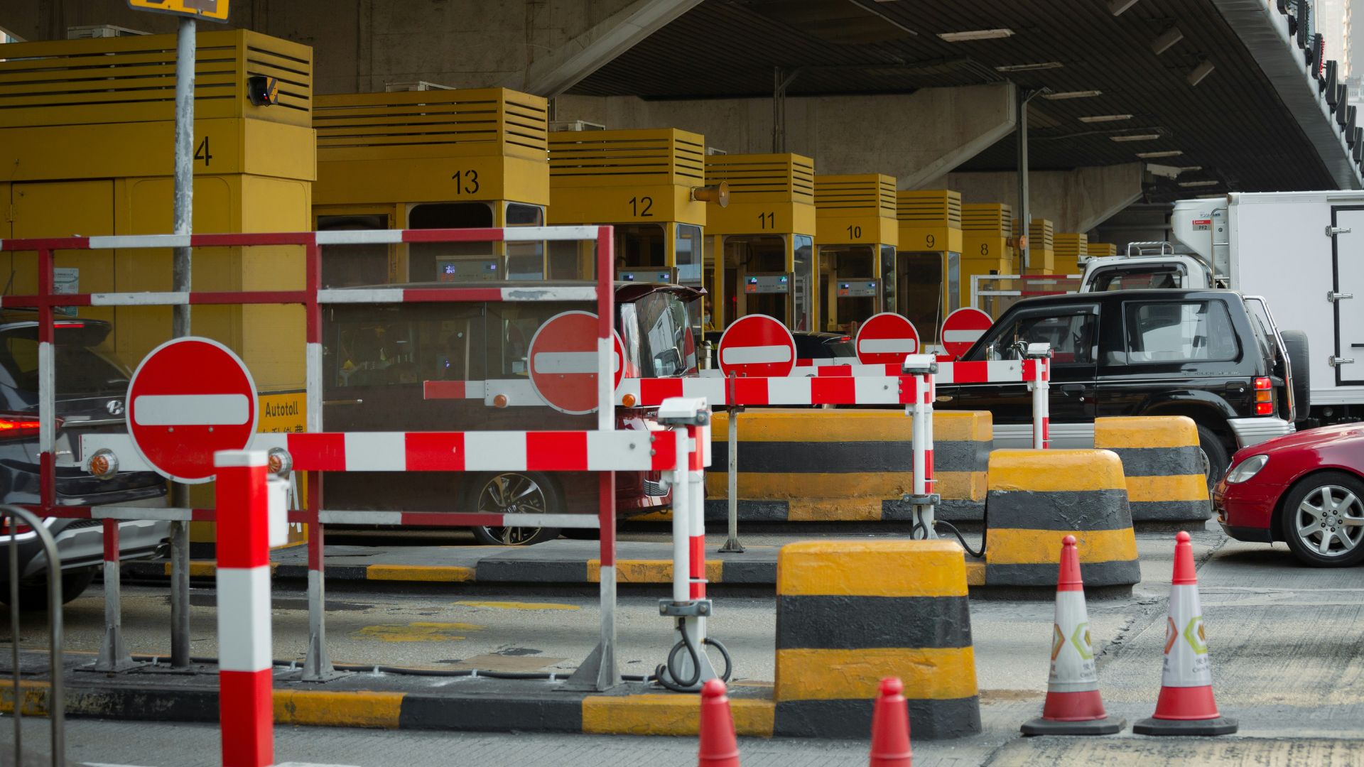 Bright red and yellow traffic cone placed on pavement