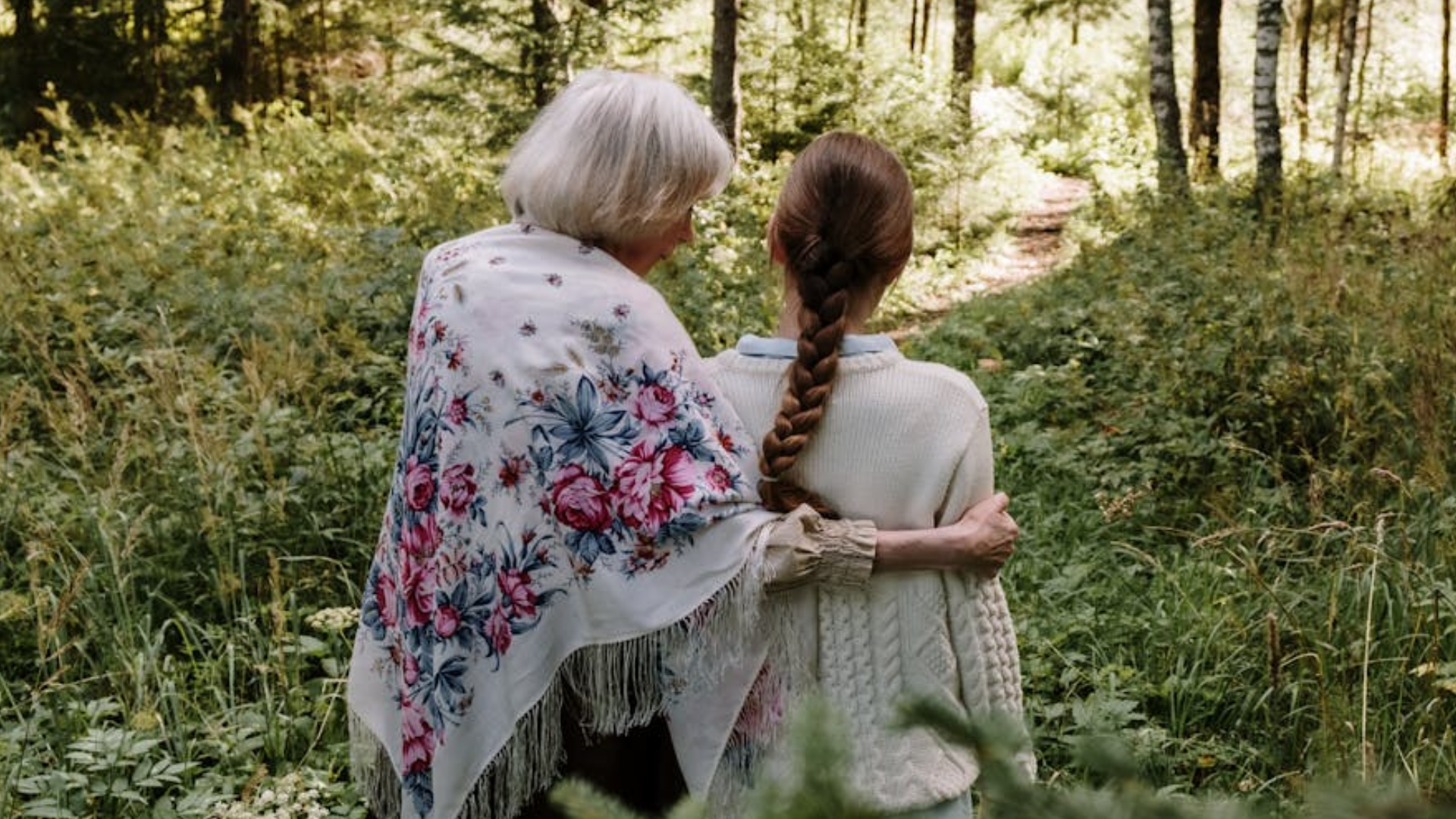 old and young woman on their backs while walking in the forest