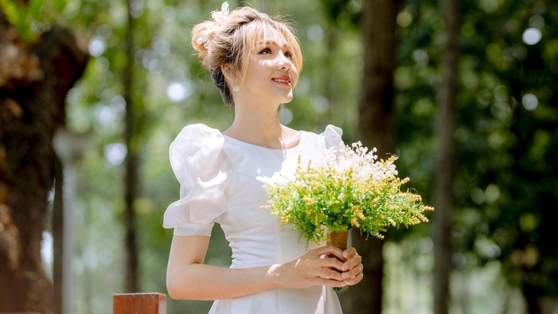 woman in her wedding dress holding a bouquet of flowers