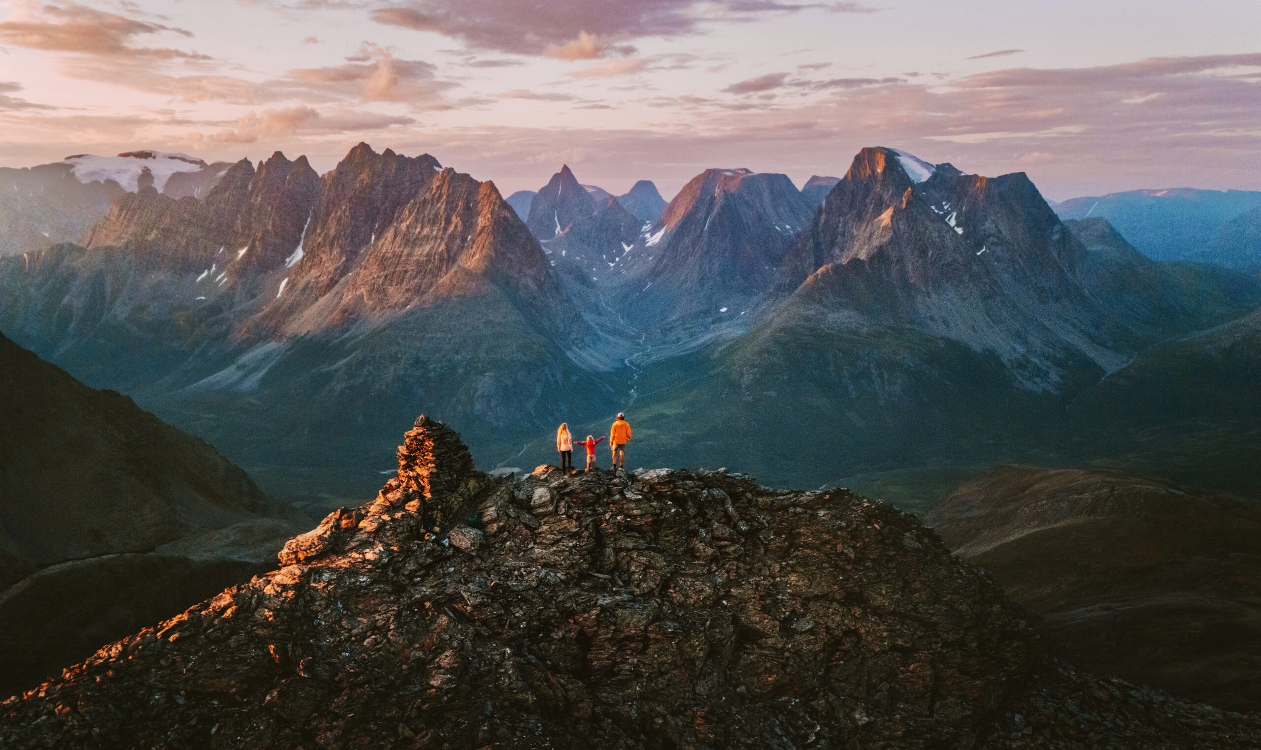 A family on a mountaintop in the Lyngen Alps, Norway