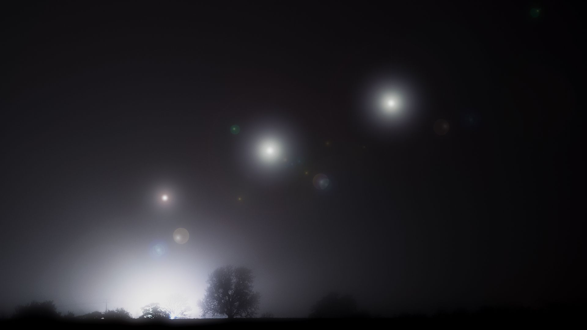 Glowing unidentified object hovering in a dark night sky