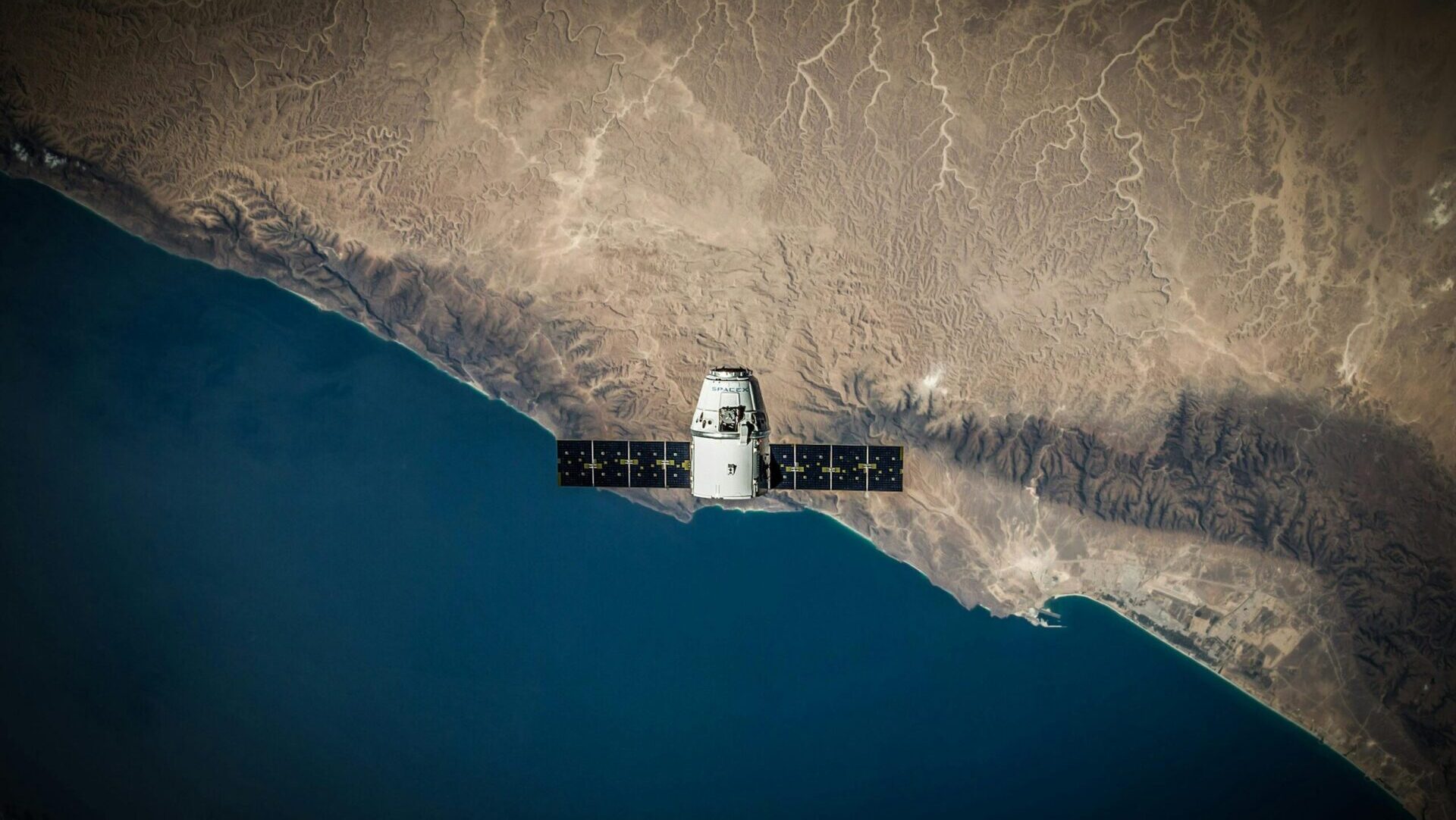 Satellite orbiting above Earth with a view of the planet’s curvature and clouds from space, capturing space exploration and Earth observation.