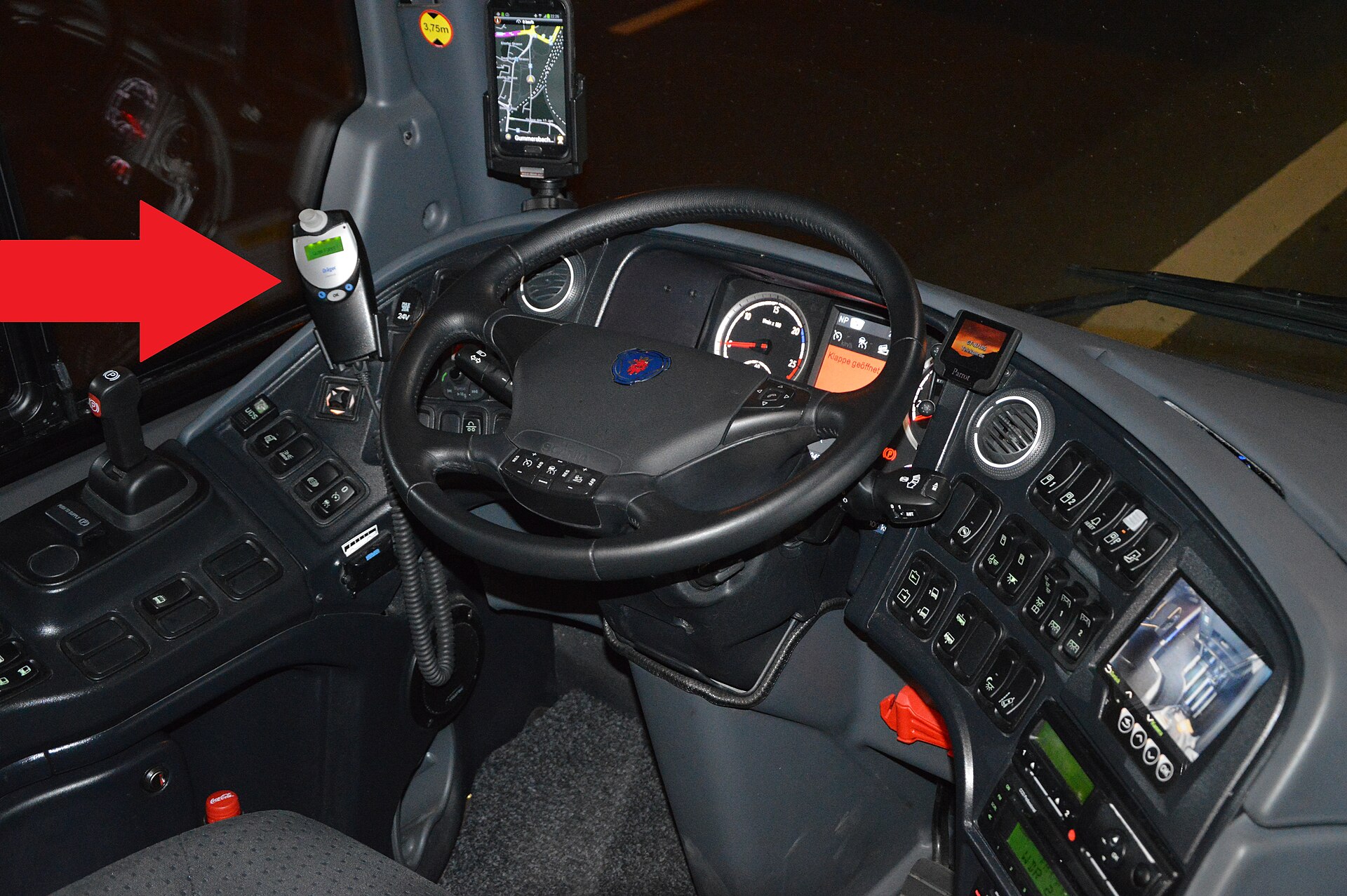 Ignition interlock device on a bus, pointed by a red arrow