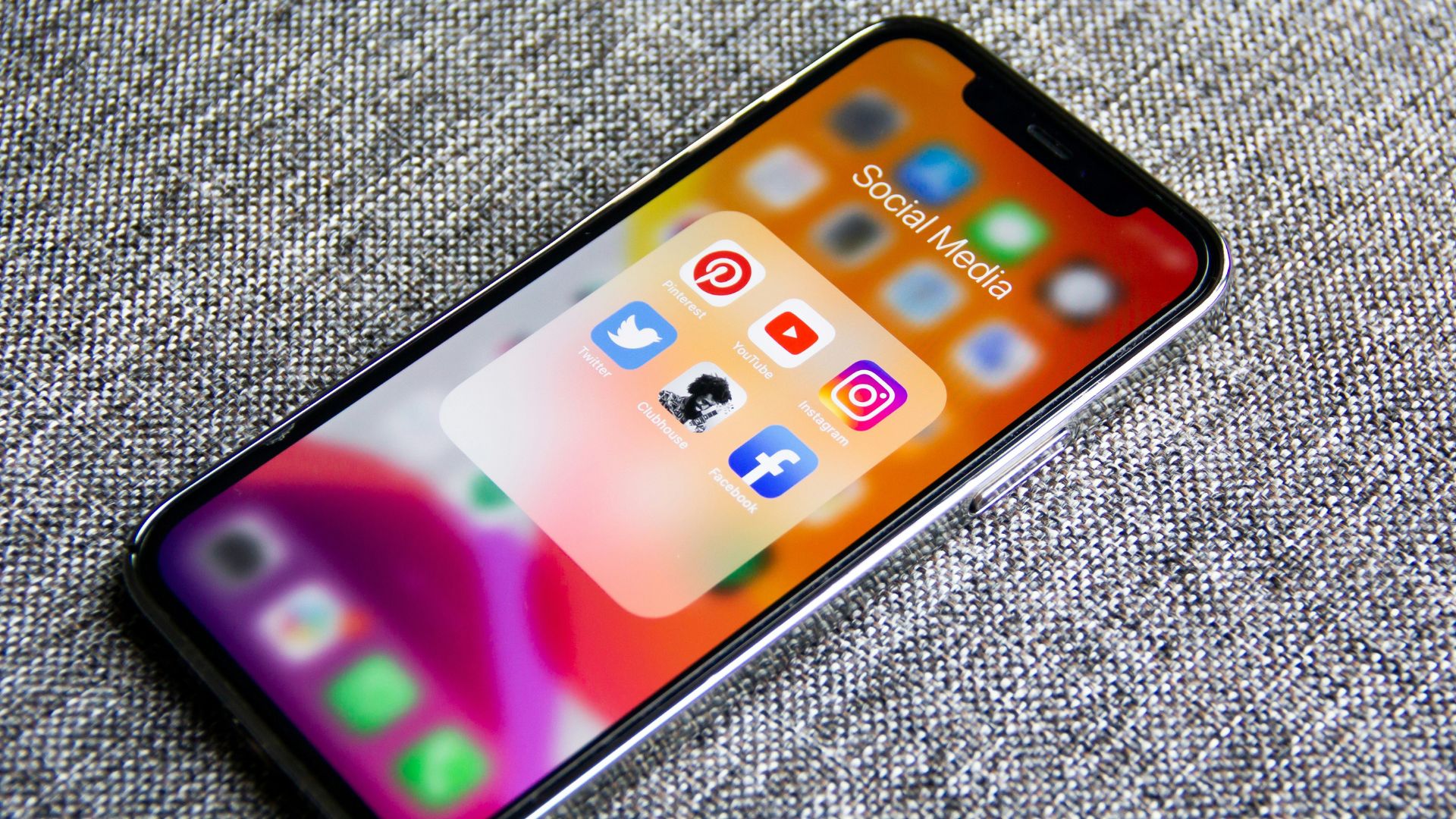 Smartphone resting on fabric representing online video sharing