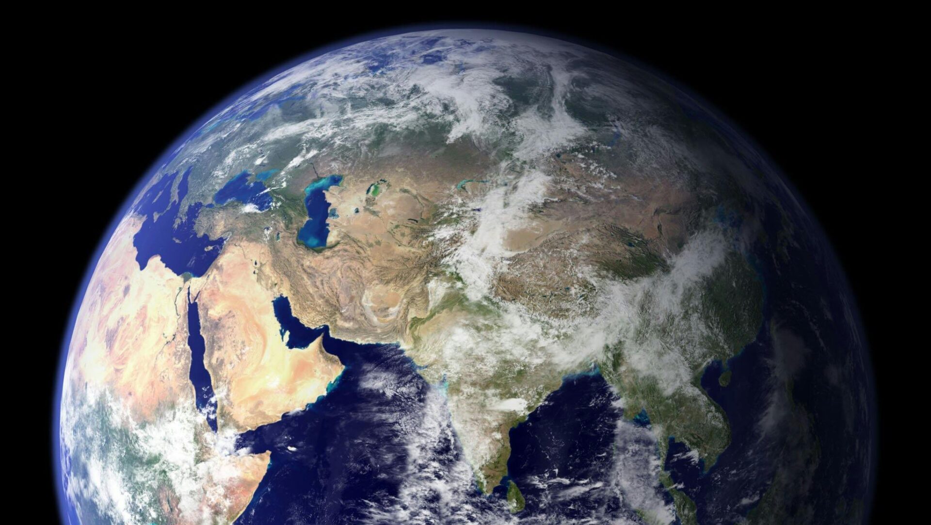 View of planet Earth from space with visible continents, clouds, and deep blue oceans.