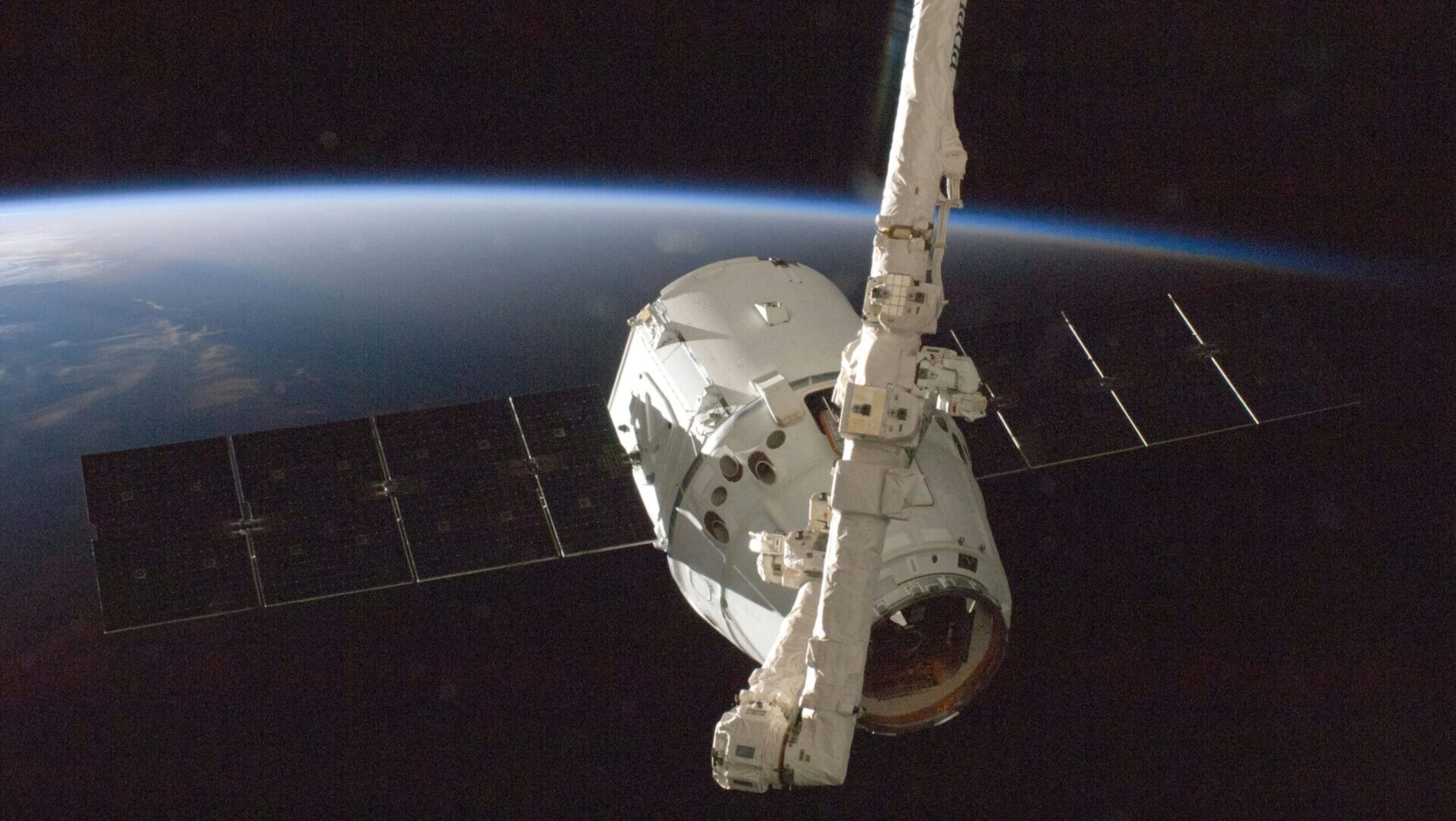Spacecraft or satellite above Earth with parts of the planet visible, symbolizing NASA research and space discovery.