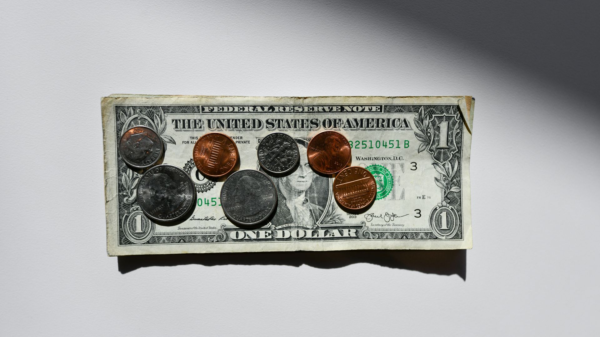 Silver and gold coins stored inside a small box