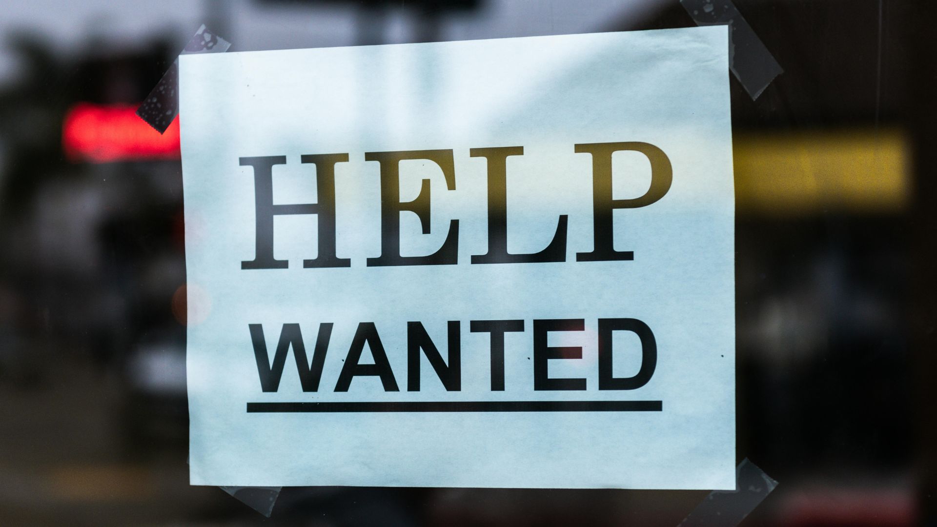"Help Wanted" sign on glass