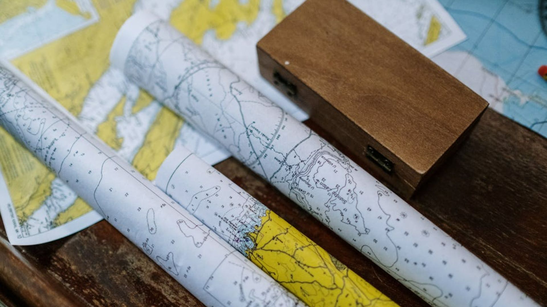 Stock photo of rolled up maps on a table