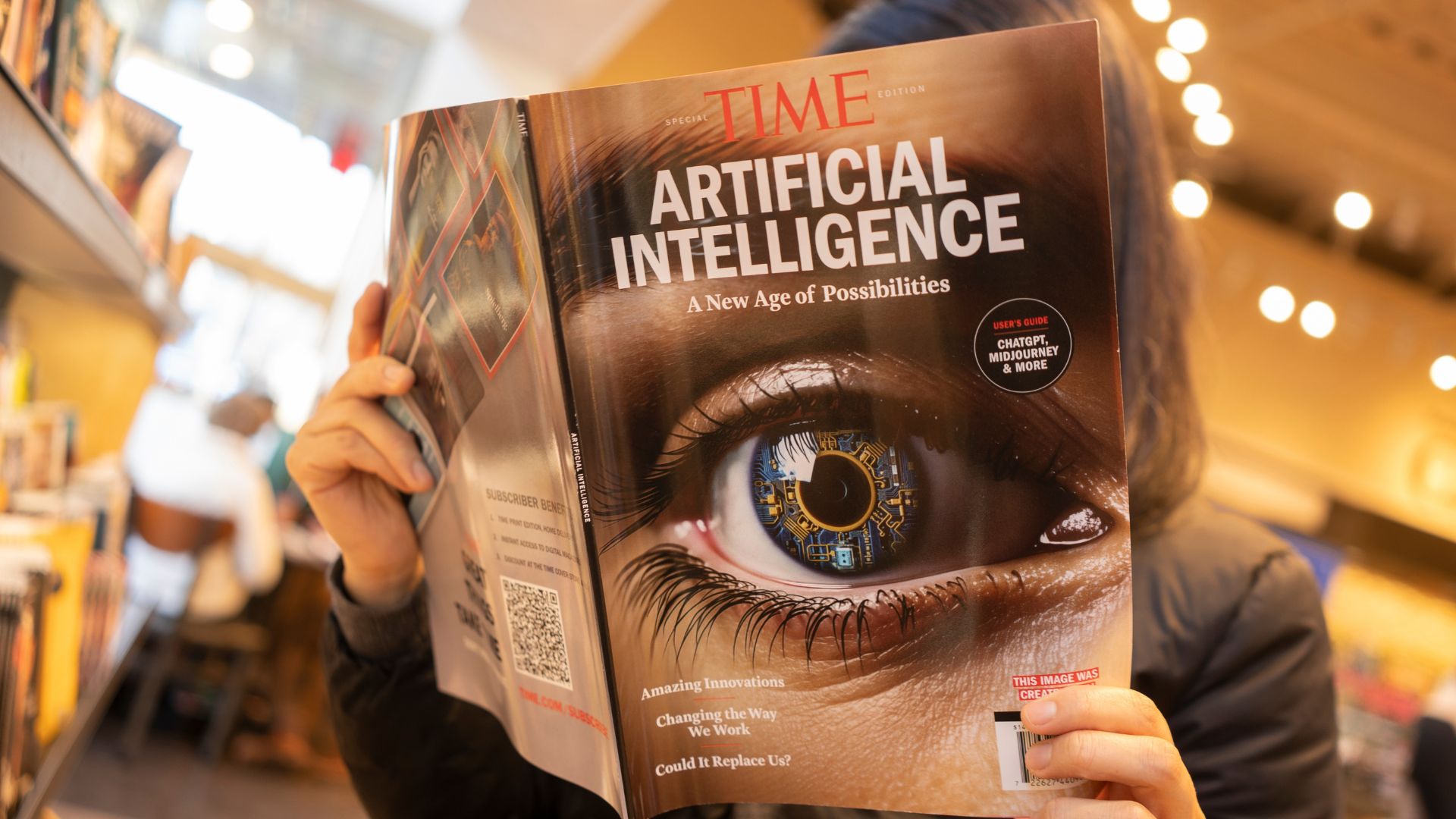 Person reading a magazine featuring artificial intelligence on the cover in a bookstore.