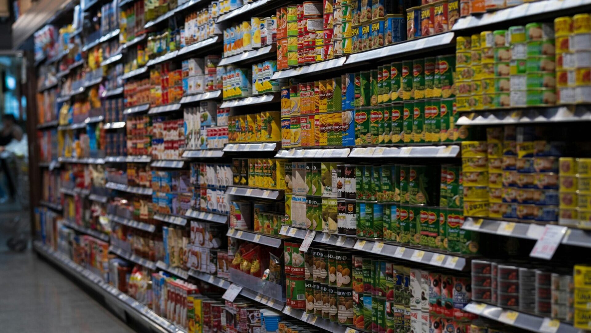 Rows of grocery store shelves stocked with various products.