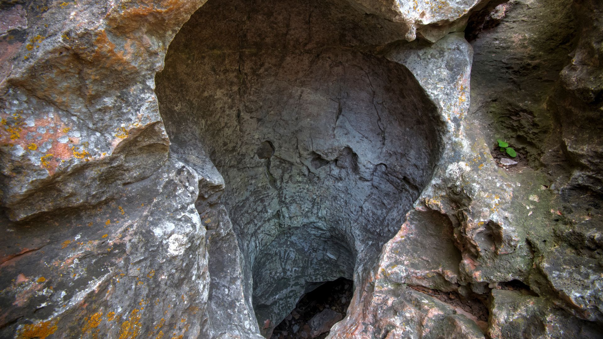 Natural cave entrance at Wind Cave National Park partially enclosed by rock formations