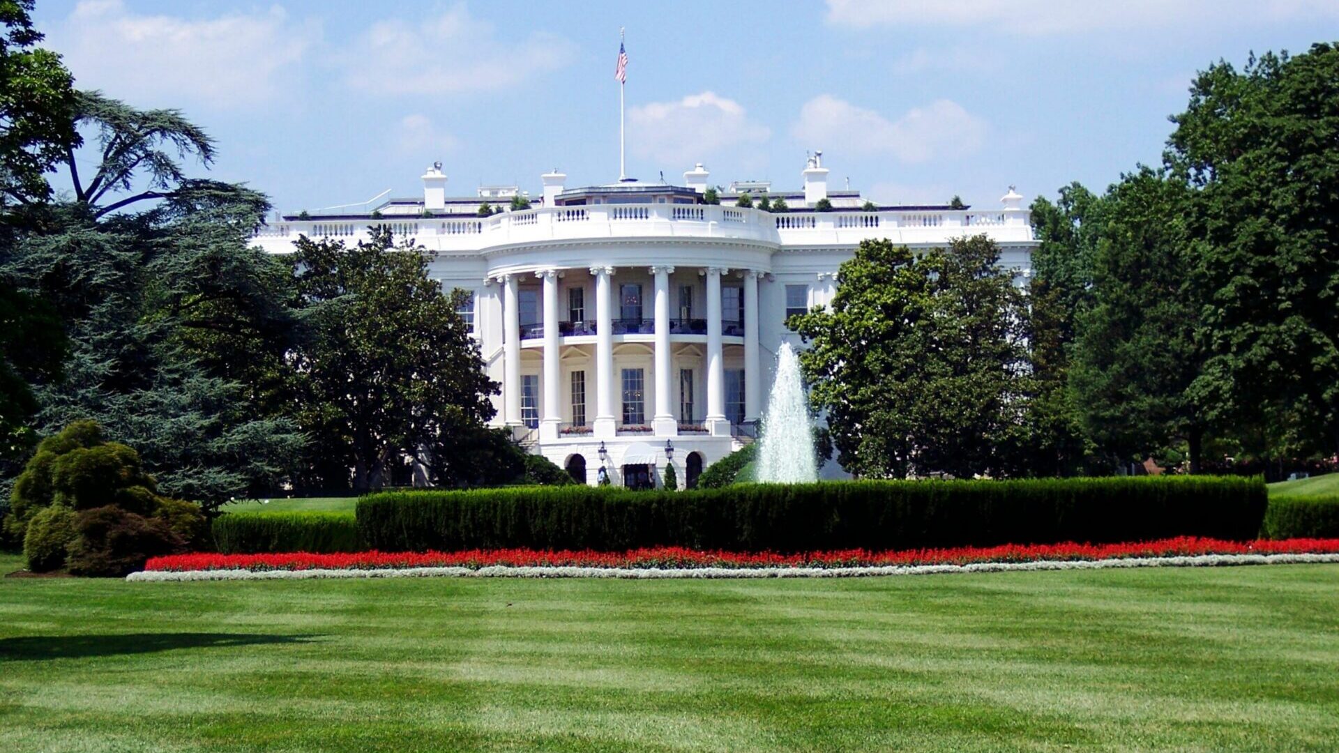 The White House exterior with its white columns and fountain in Washington, D.C.