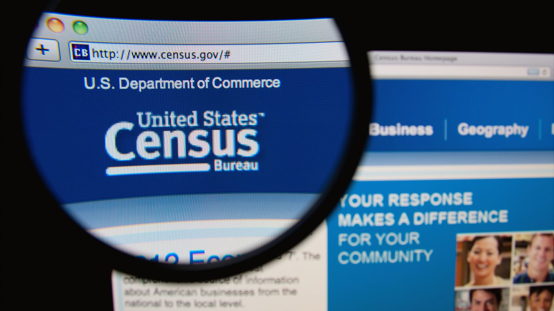 United States Census Bureau website displayed on a computer monitor viewed through a magnifying glass