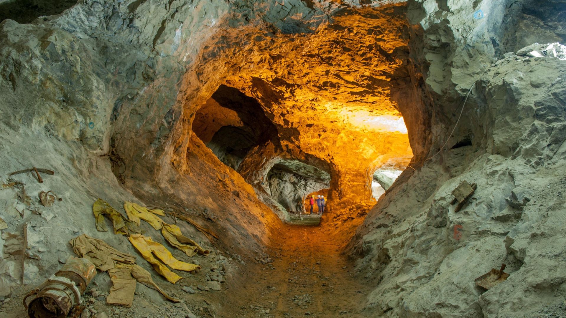 Illuminated underground mine corridor with stable rock walls