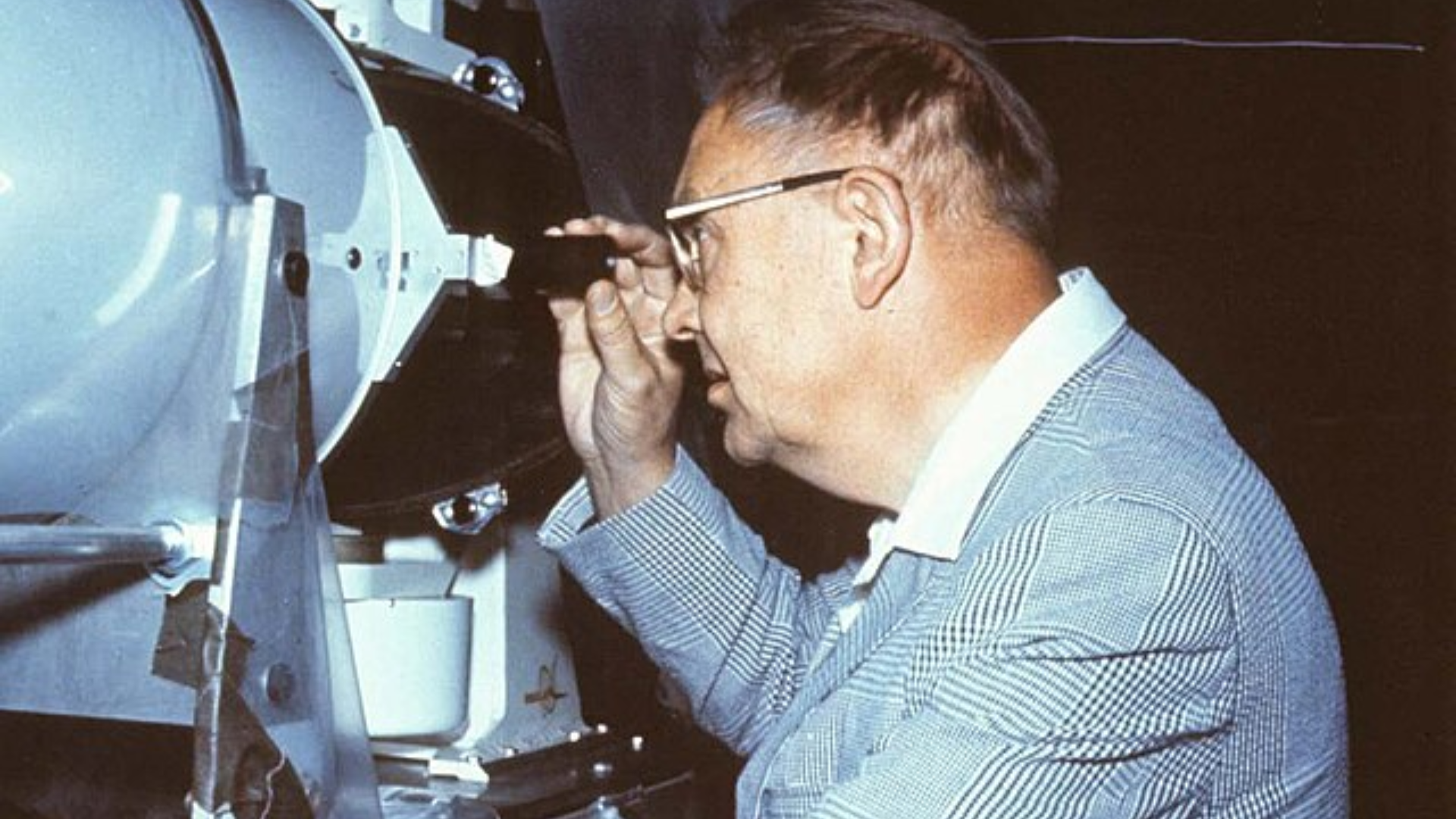 Astronomer reviewing telescope.