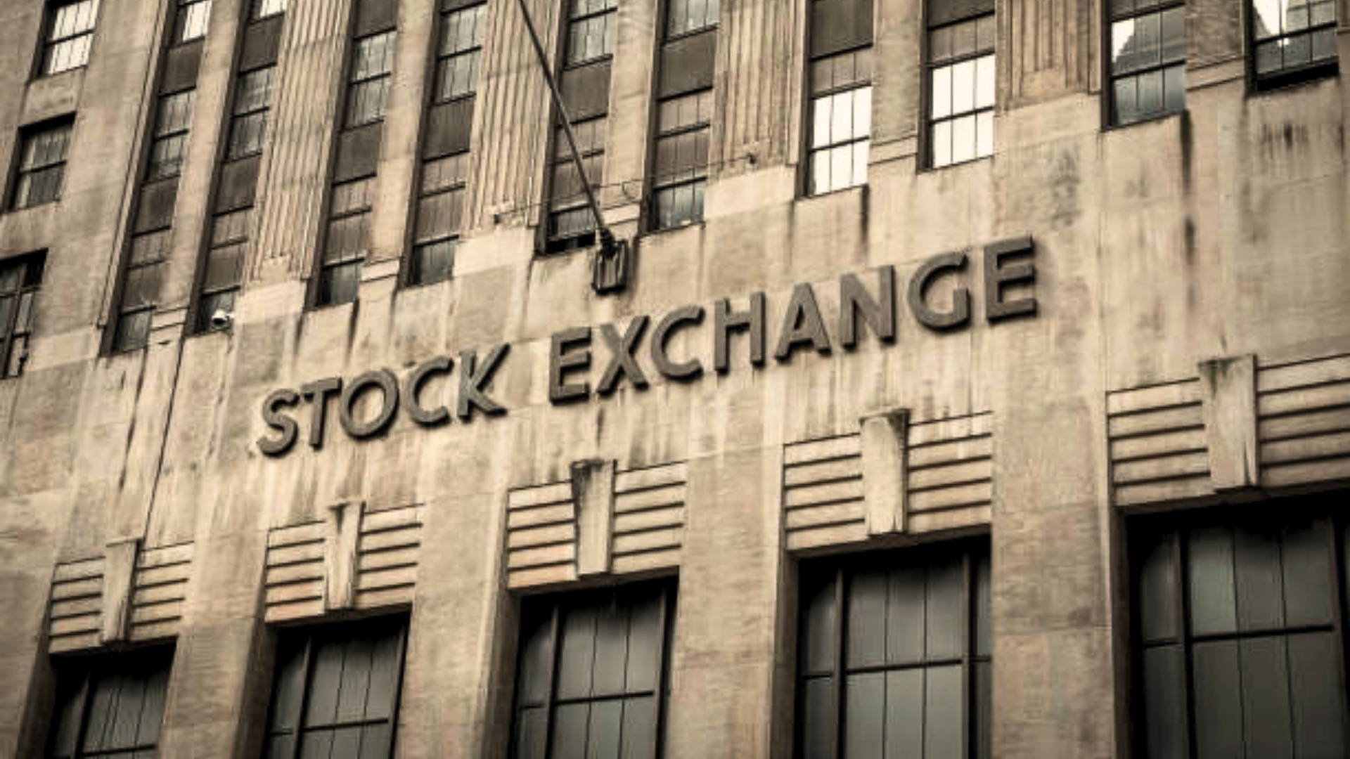 Facade of a historic building with the words “Stock Exchange” displayed.