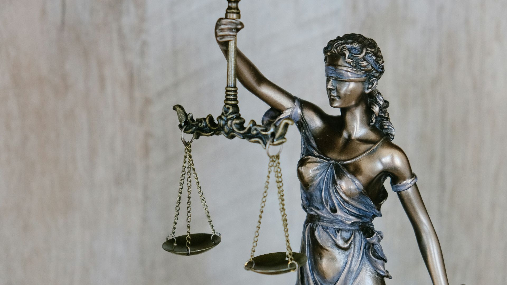 Statue of Lady Justice holding scales and wearing a blindfold.