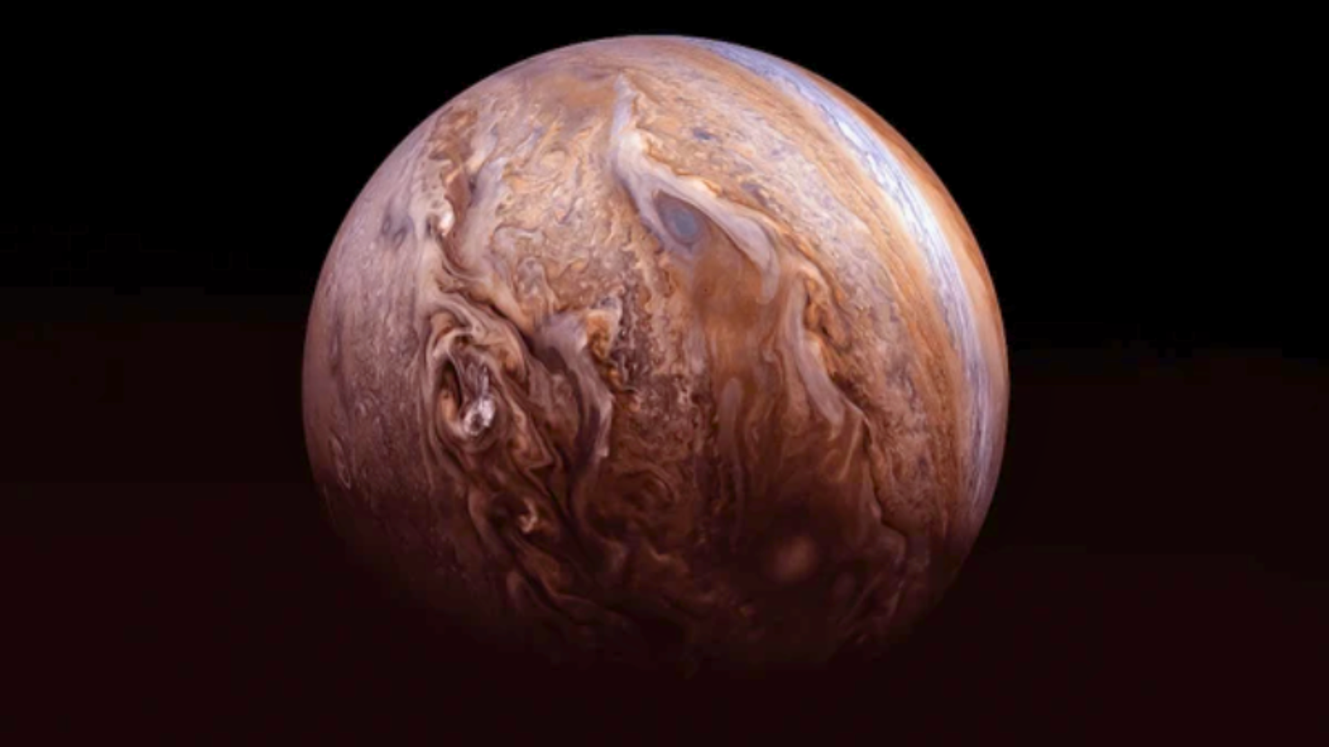 High-resolution view of Jupiter’s atmosphere showing detailed brown and white clouds and the Great Red Spot.