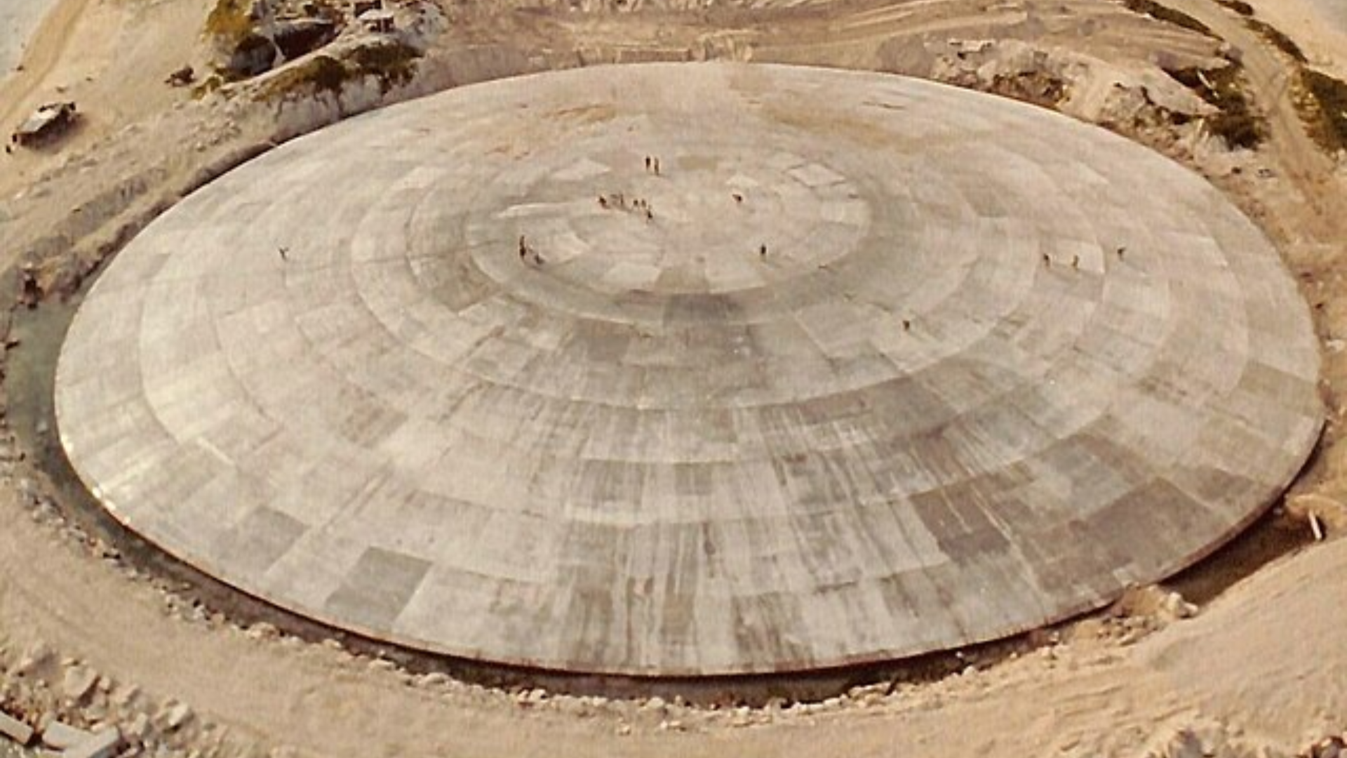 An aerial view of the Runit Dome, a massive concrete lid built on Runit Island to contain radioactive debris from nuclear testing.