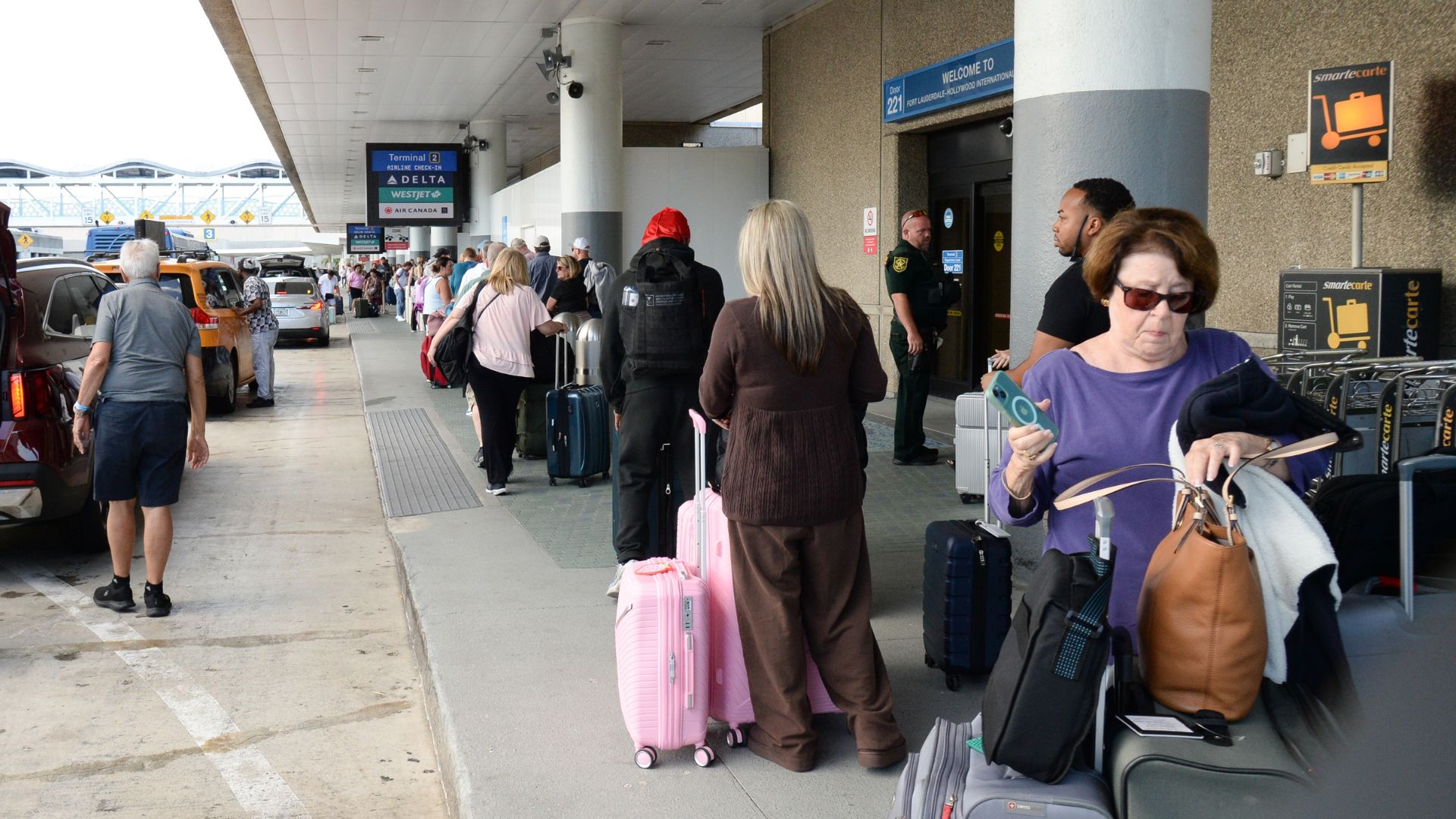 Travelers line up at security checkpoints at Fort Lauderdale-Hollywood International Airport.