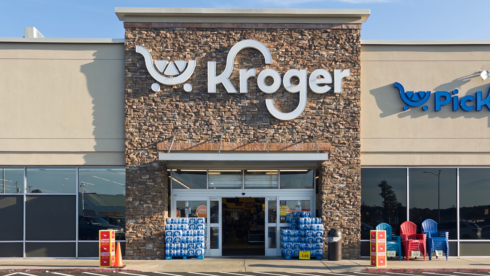 Photo of Kroger store entrance with merchandise on the front.