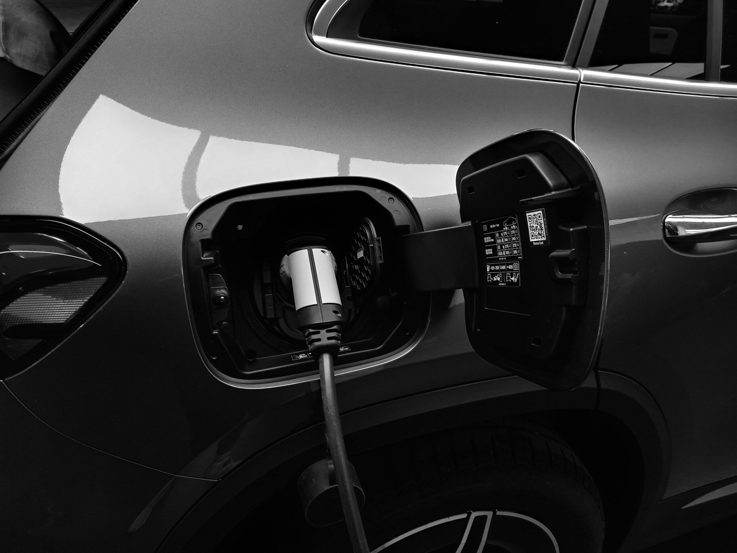 Electric vehicle charging through cable connected to side port.