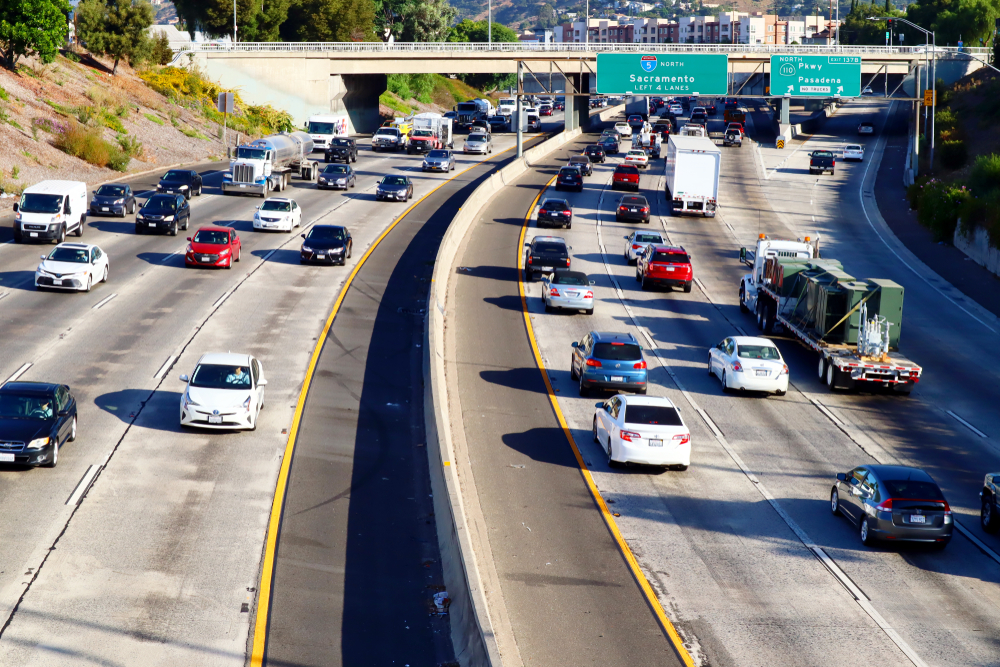 Traffic moving along Interstate 5 with signs directing drivers toward Sacramento and Pasadena.