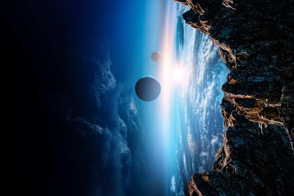 Rocky cliff overlooking a planet’s curved horizon with two moons visible in the sky above a glowing sunrise.