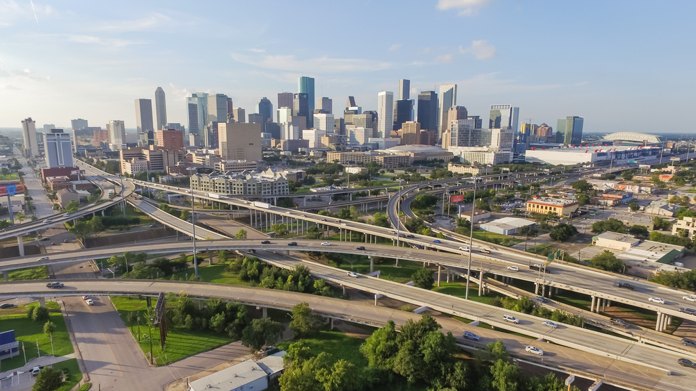 Aerial view of Interstate 45 and Interstate 69 interchange with downtown Houston skyline in the background.